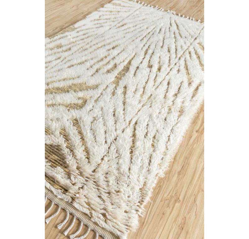 Ever dreamt of owning a mosaic masterpiece for your floor? Look no further! This hand-knotted rug by reimagines classic Moroccan tile motifs in a contemporary, distressed style, its plush handspun wool offering both comfort and timeless appeal.