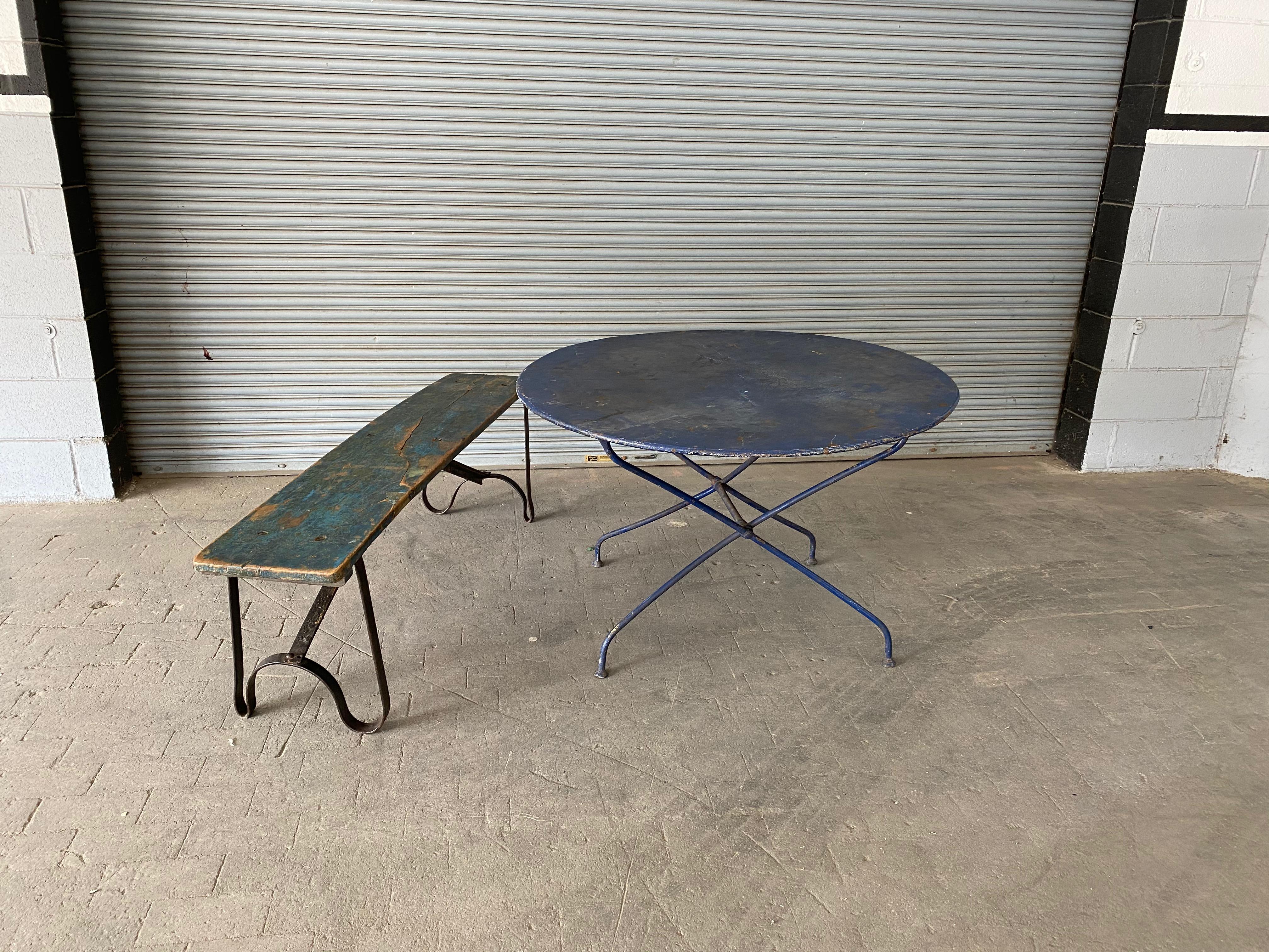 A French 1920s industrial wood bench with a curved iron base. Make a bold impression in any space with this stunning French industrial wood bench from the 1920s. This sturdy piece features a curved iron base and a beautiful wooden top with a