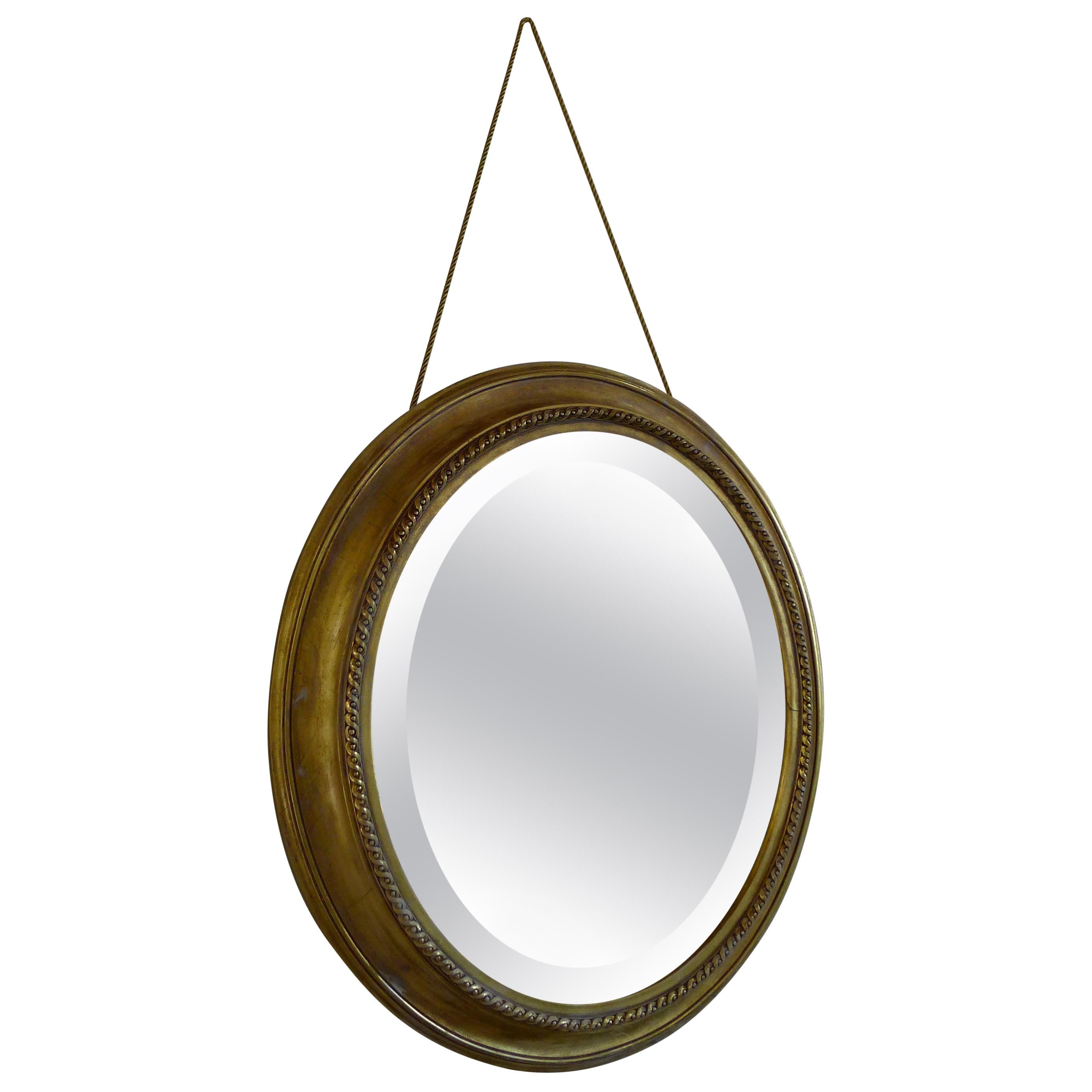 Distressed Gilt Oval Antiqued Mirror Hung by Rope For Sale