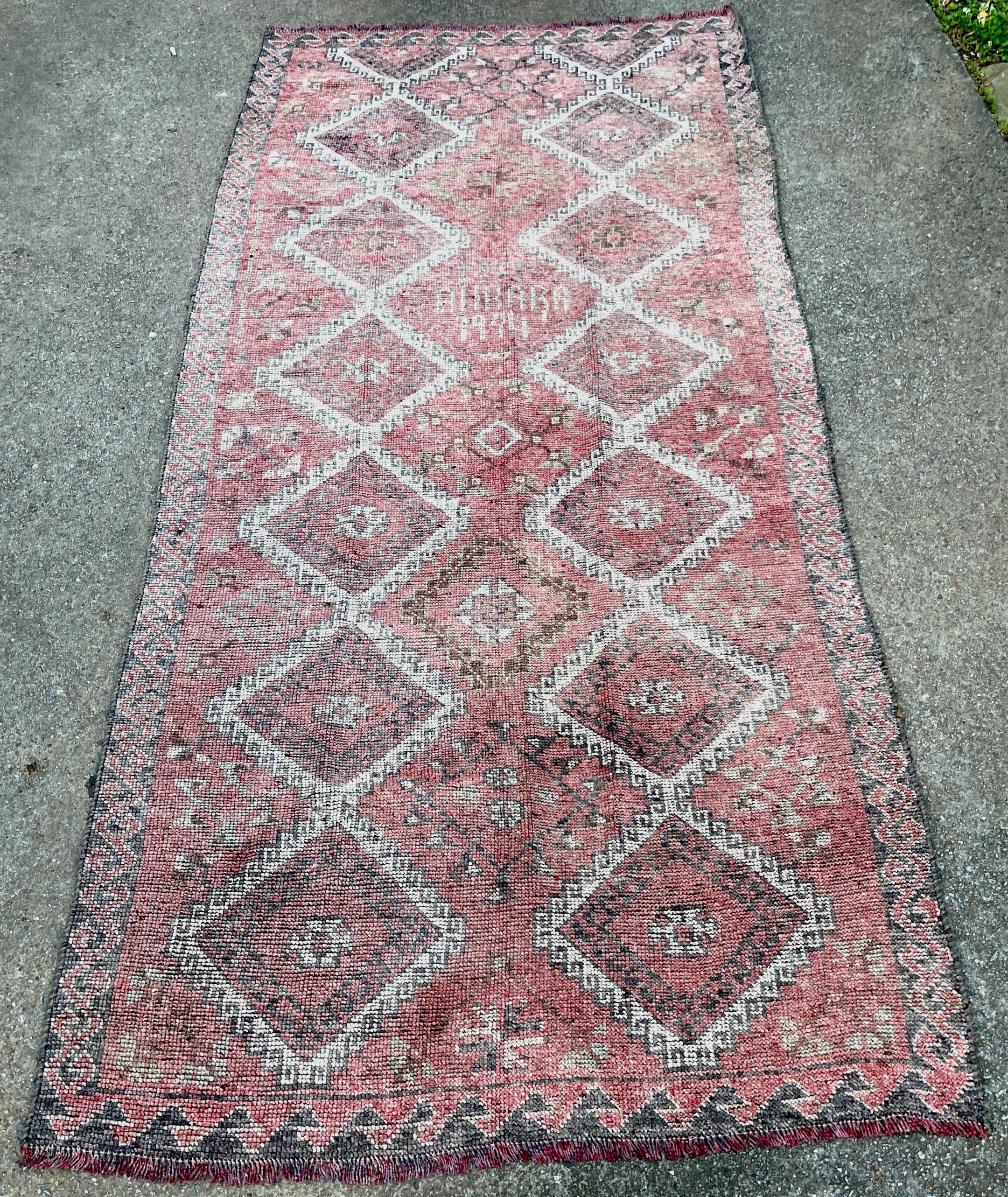 Distressed Hand-Knotted Wool Caucasian Rug (Reservable) Signed & Dated 1994
Generous in size and proportions, subtle diamond pattern, in hand-dyed red and whites, with some black additions. Can be used on either side, one side is darker.
Signed in
