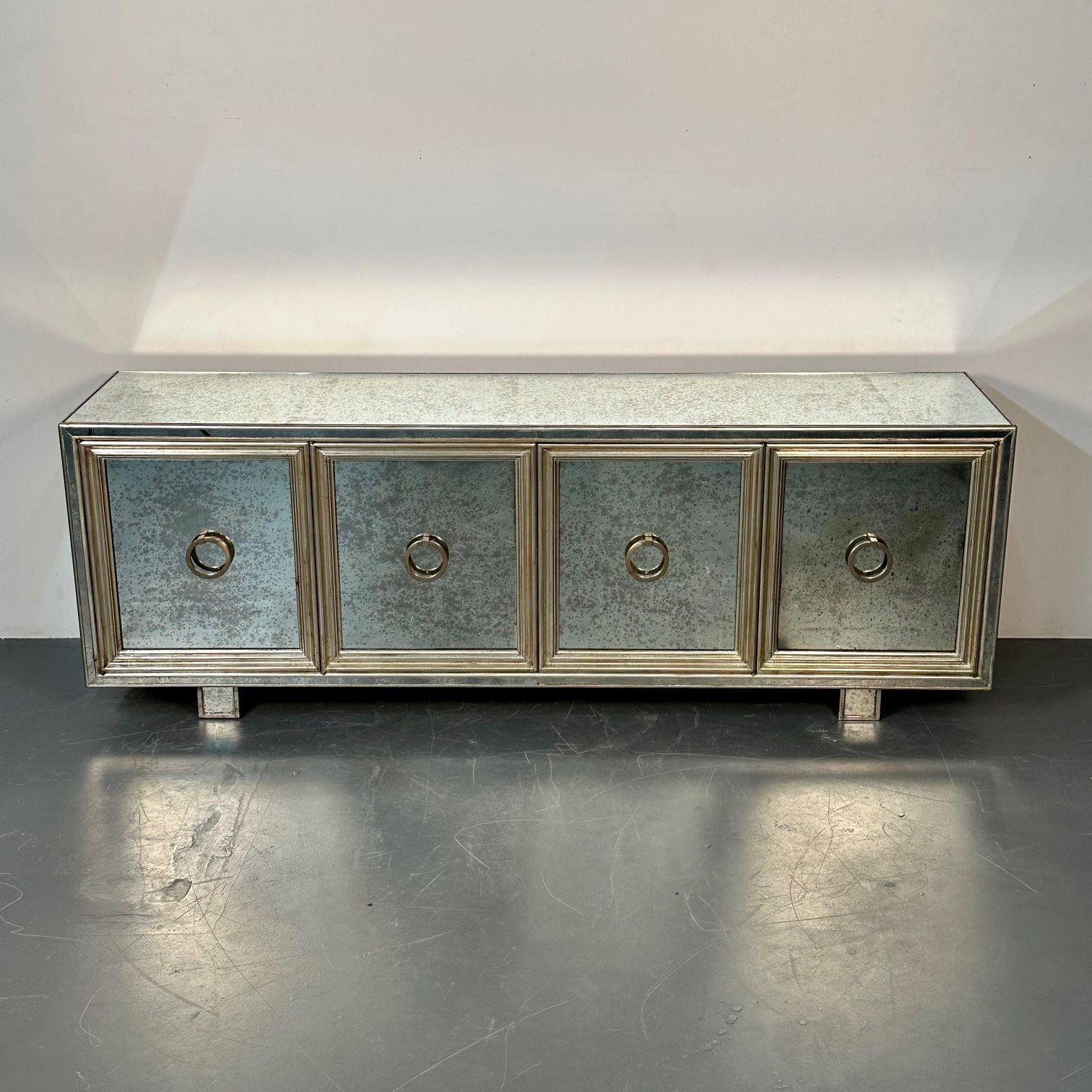 Hollywood Regency, Sideboard, Distressed Mirror, Silver Gilt, USA, 2000s

Four mirrored front doors hiding a set of ebony shelved interiors. The case itself is absolutely spectacular with mirrored cube feet supporting a large and impressive cabinet