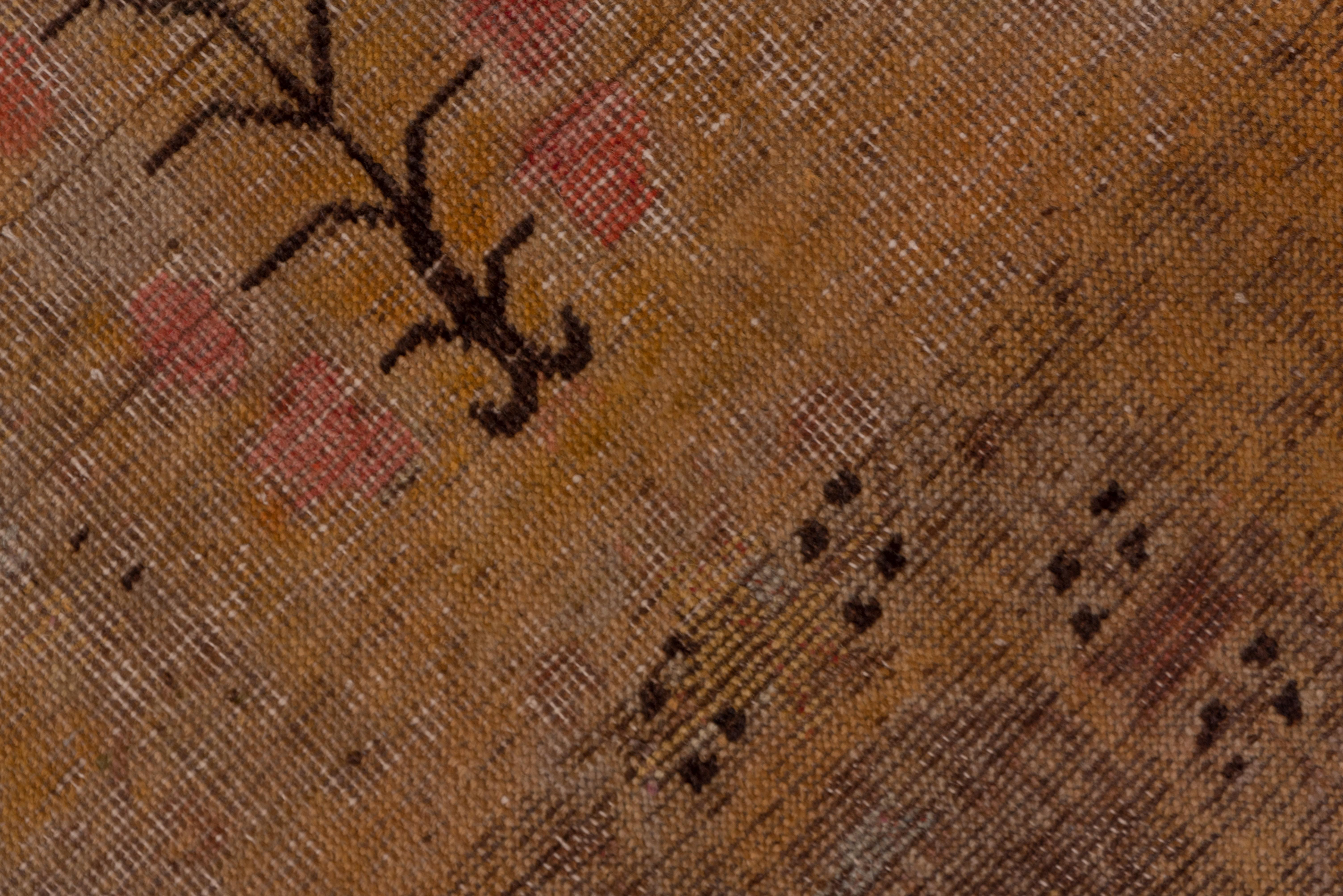 This east Turkestan oasis town rug still preserves a design in dark brown of volute knots, long-stemmed flowers, and a central small medallion, all on the straw ground. Brown accents the simplified Yun-Tsao Tou border. The palette is quite narrow.