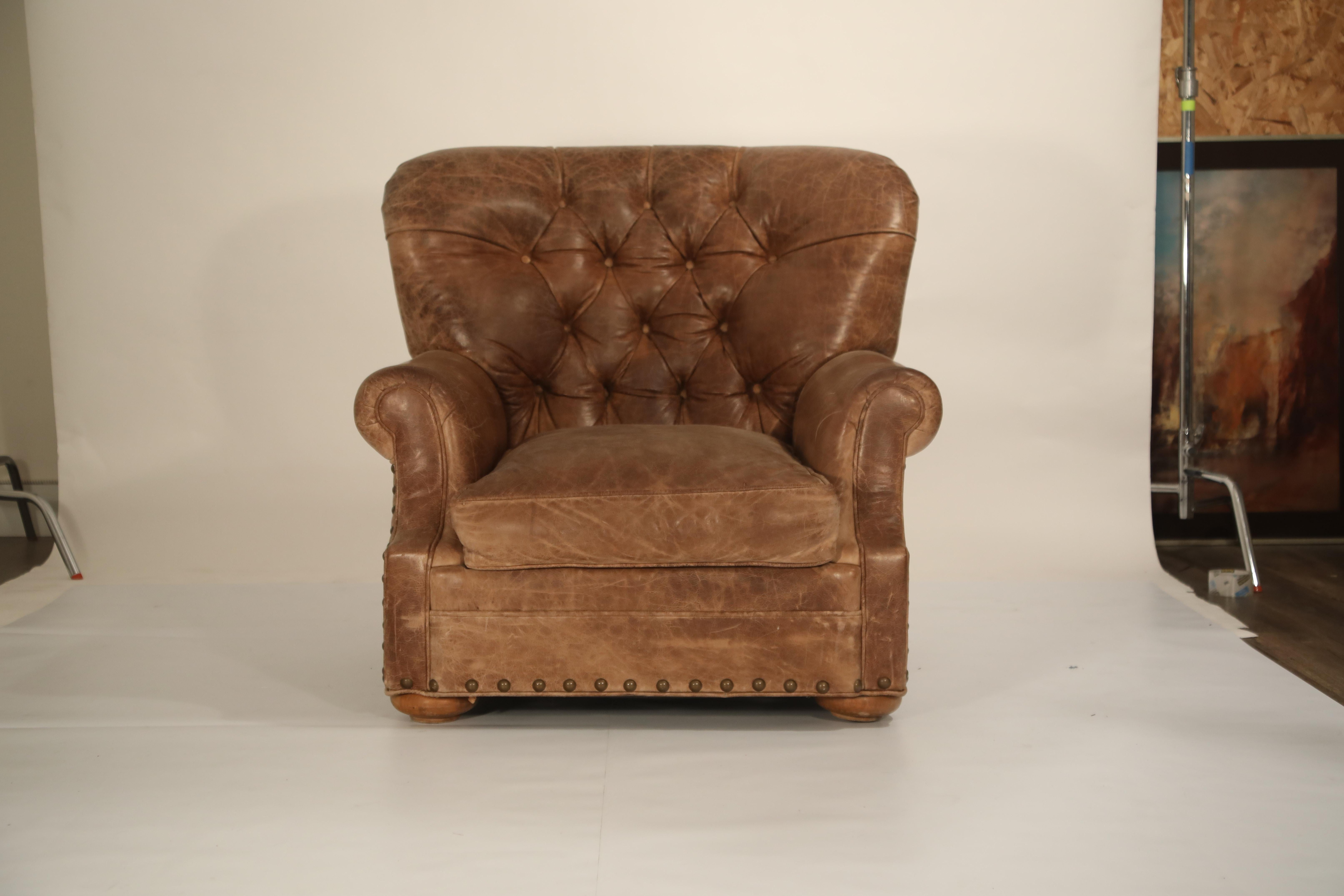 Handsome leather armchair and ottoman pairing in the style of Ralph Lauren's 