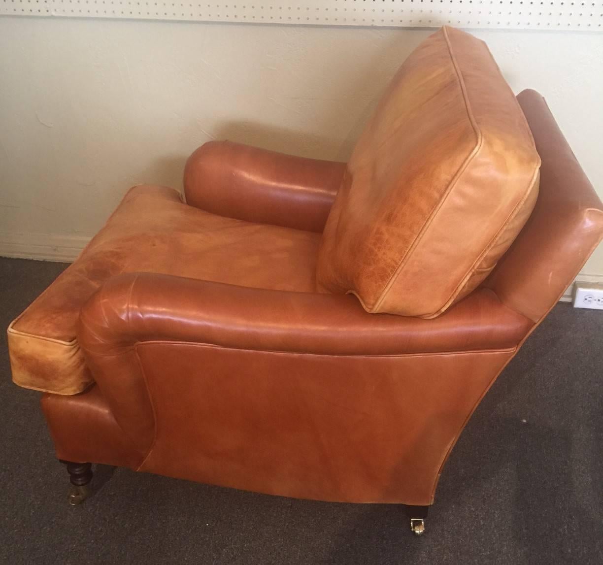 A Classic distressed leather club chair by renowned English furniture maker George Smith. The chair feature solid wood turned legs with brass casters. Great traditional look!