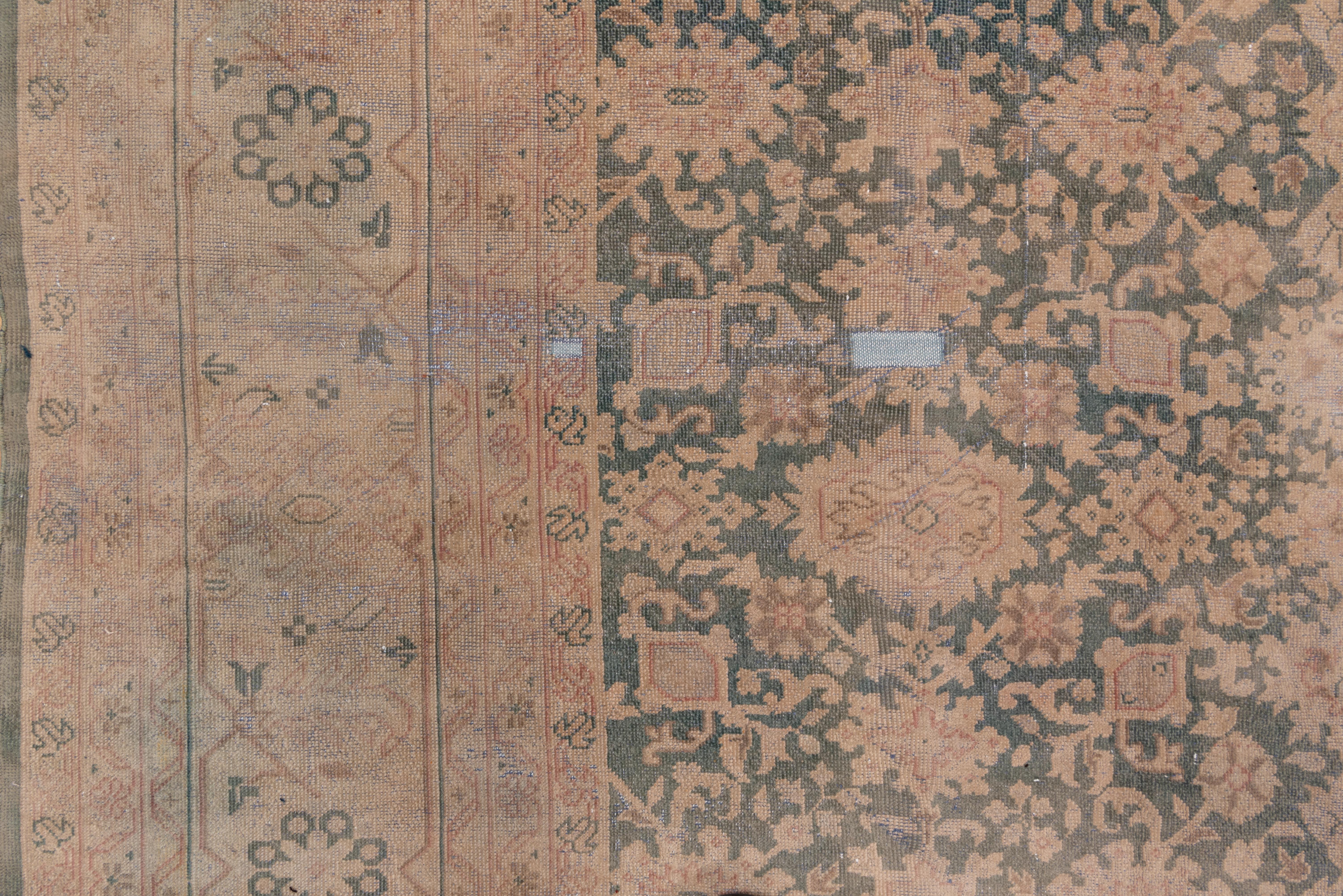 This distressed west Persian village carpet presents a Harshang -like pattern of relatively small ragged palmettes, pointed ovals and tiny filler flowers, all on the brownish red ground. Border of rosettes and barbed diamonds.
  