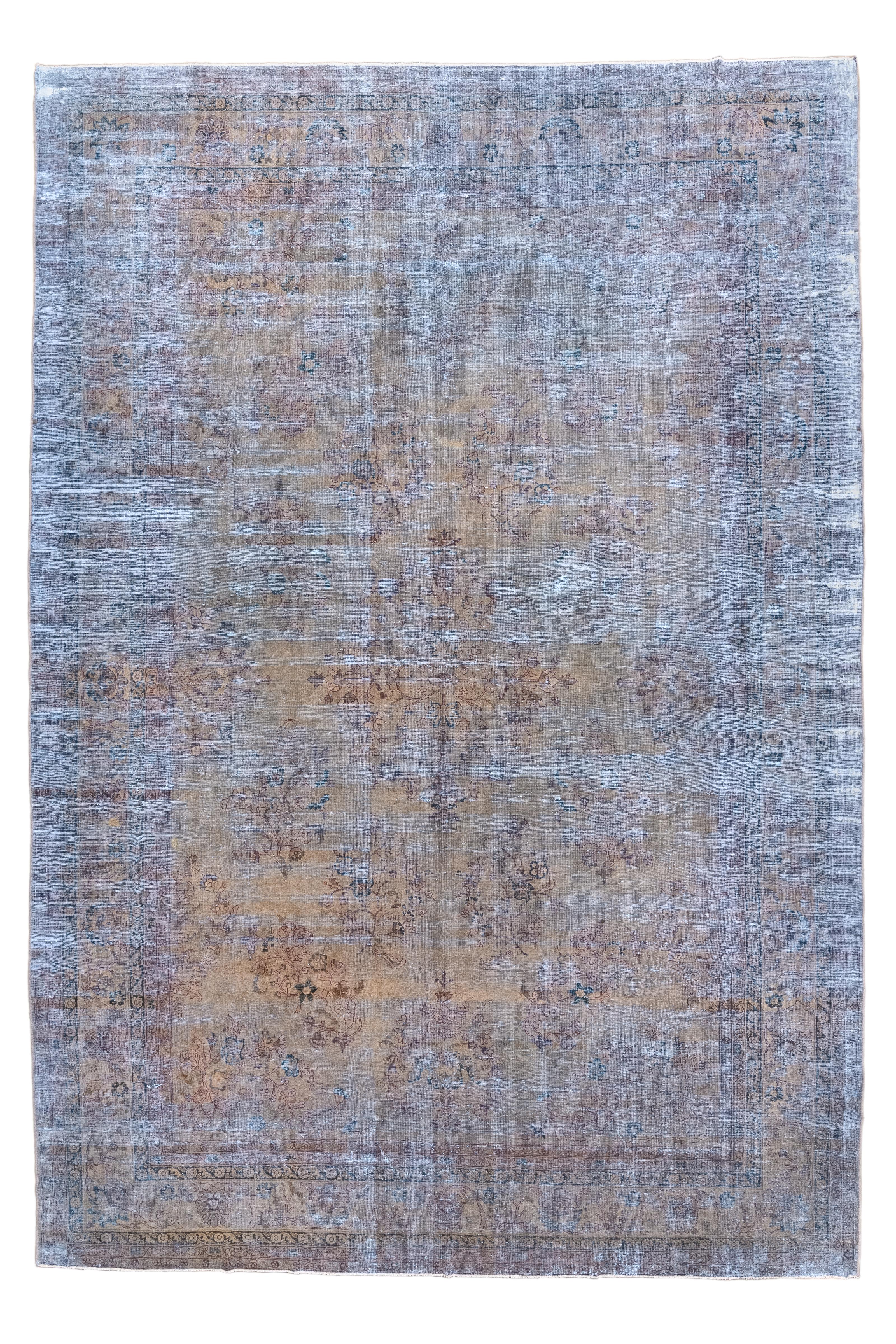 The runs of white foundational cotton on this distressed village carpet, add to the basic tonality of dusty rust and dark blue in a field of detached floral sprays. Camel strip style main border with palmettes, stems and boteh-buds. 

Rug