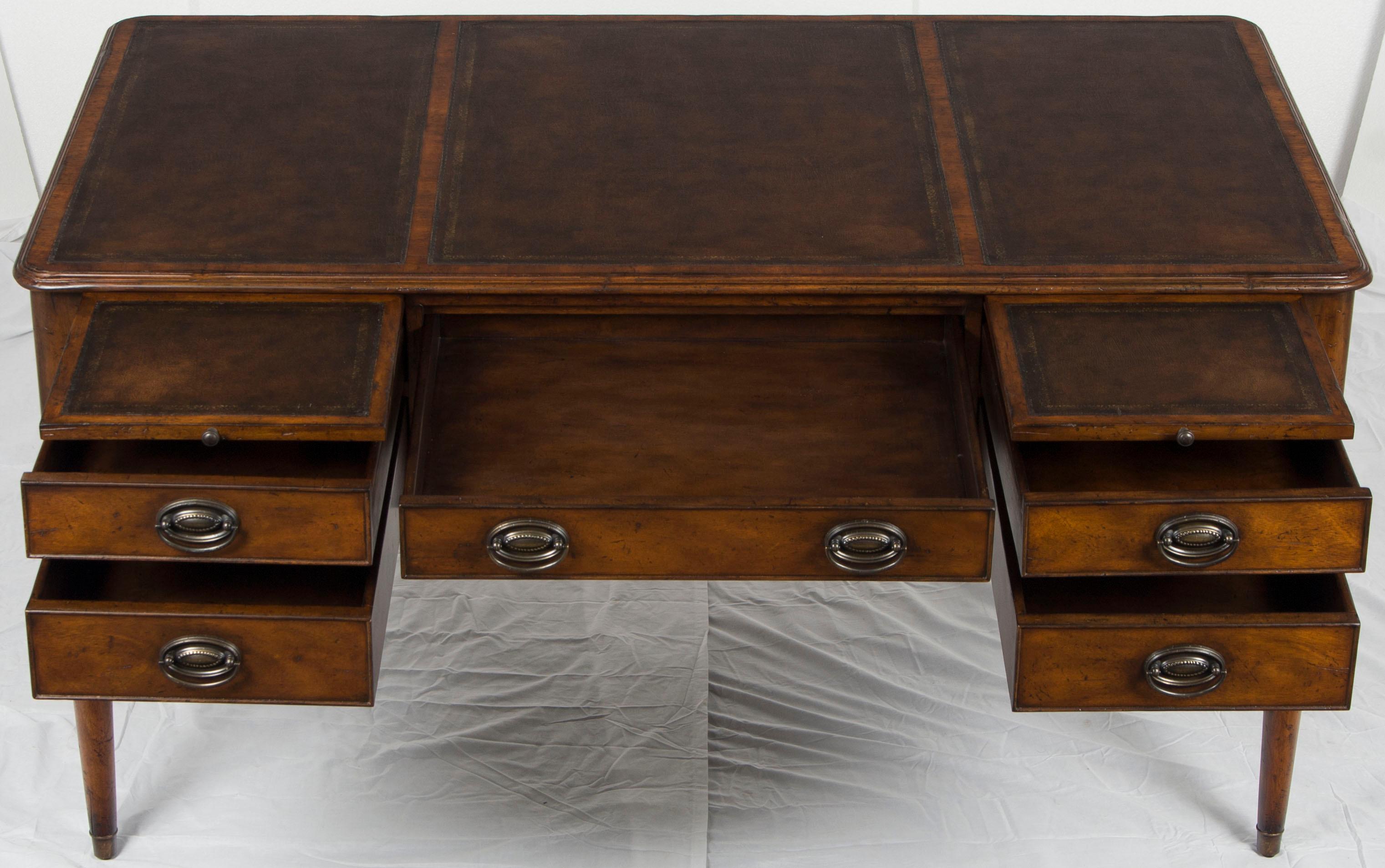 This is a brand new, heirloom quality desk on legs. Its heritage began recently when it was carefully handcrafted using only the finest hand techniques. From their selection of fine mahogany wood and gorgeous brown leather to the hand cut dovetails,