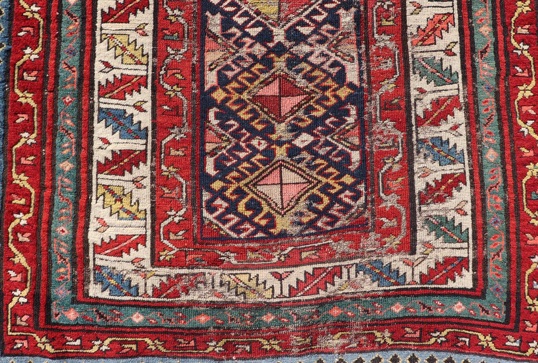 Distressed Geometric Medallion antique Caucasian Kazak rug in lighter tones. Keivan Woven Arts / rug KBE-220101, country of origin / type: Iran / Caucasian Kazak, circa 1900.

Measures: 3'5 x 10'3