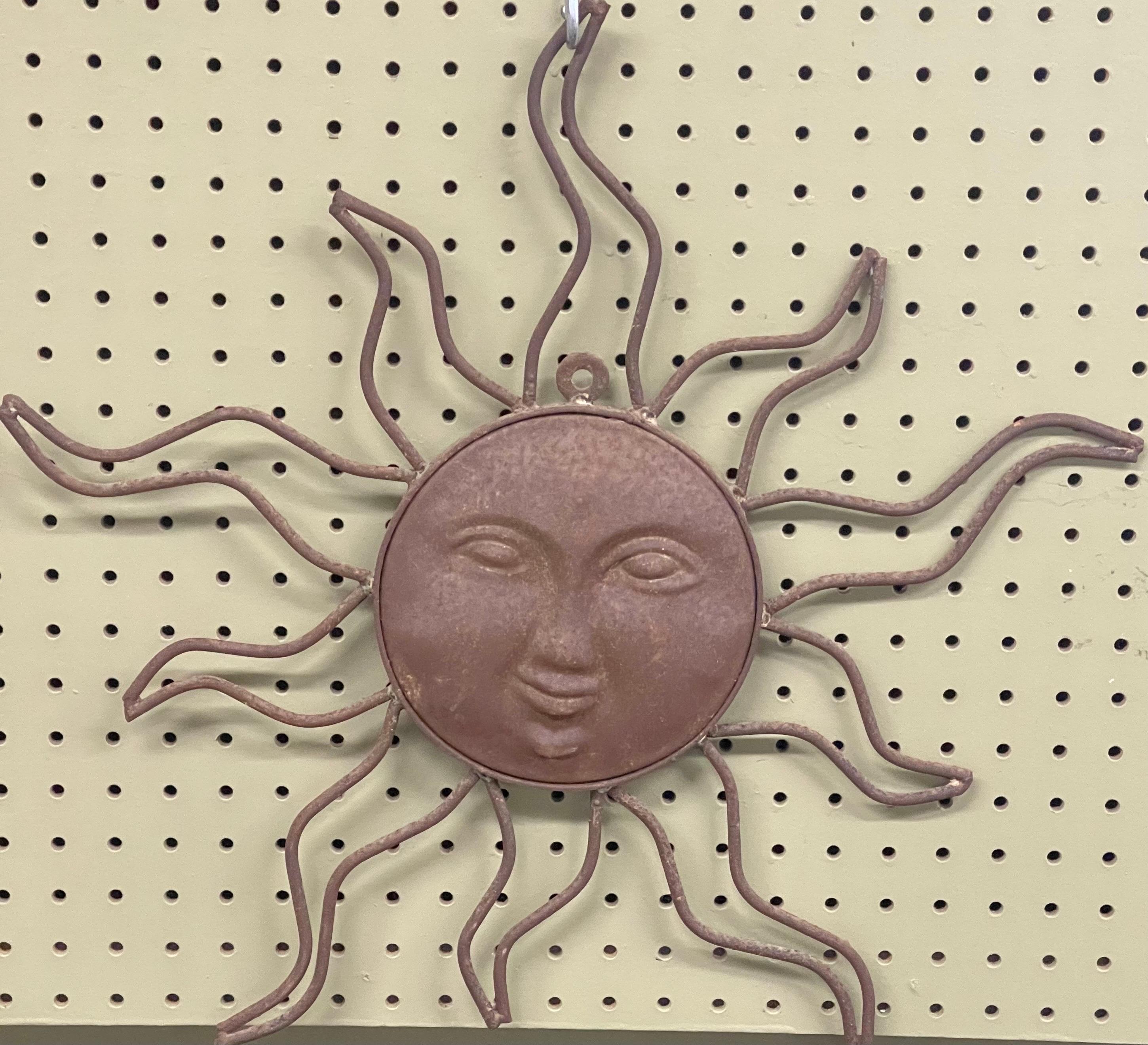 A very cool handmade distressed metal sun sculpture / wall hanging, circa 1980s. The piece is 20