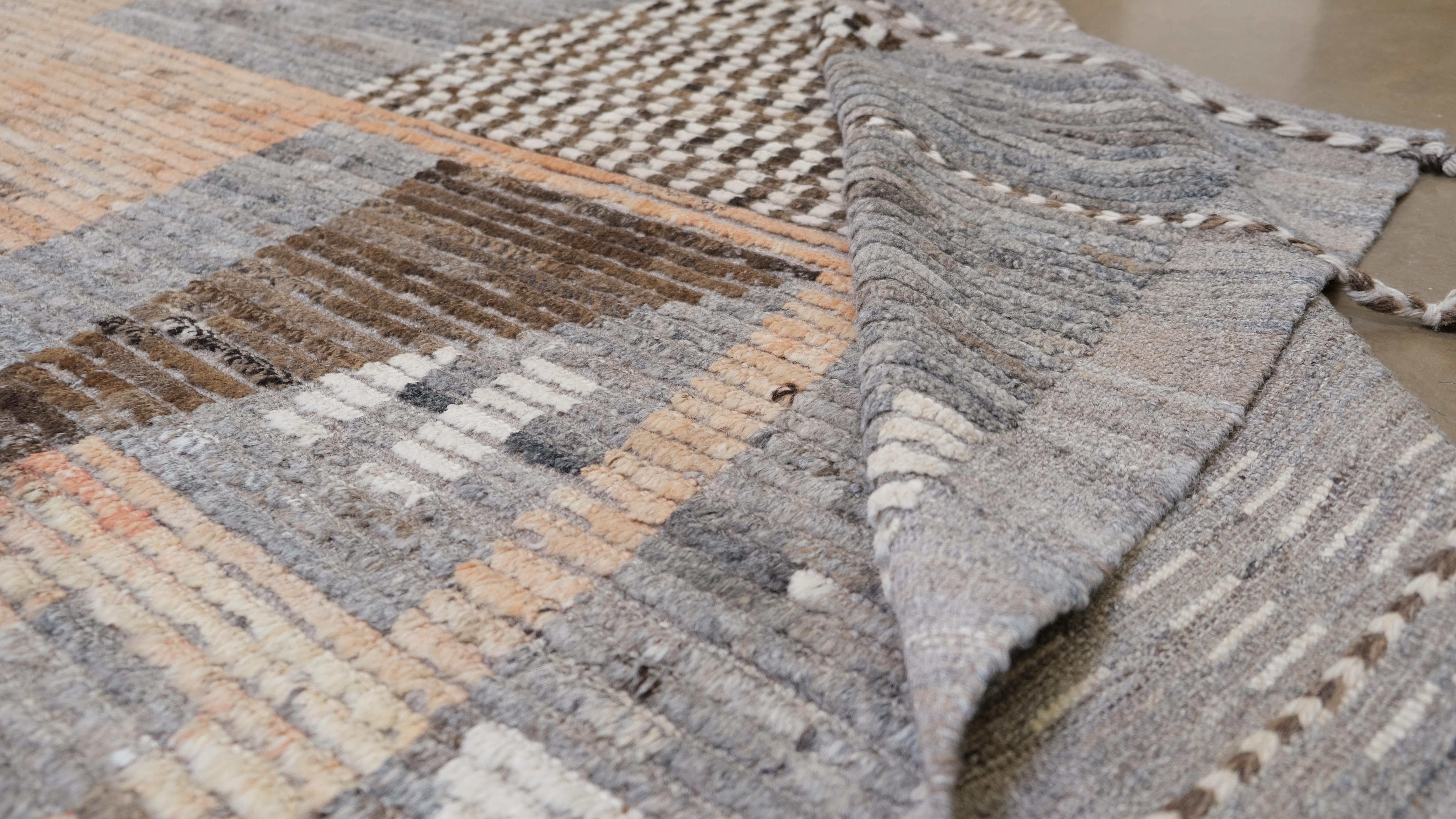 Elevate your interior design with this stunning handwoven wool rug featuring a striking geometric modern design in a blend of earthy tones. This versatile piece is a perfect balance of traditional craftsmanship and contemporary aesthetics, making it