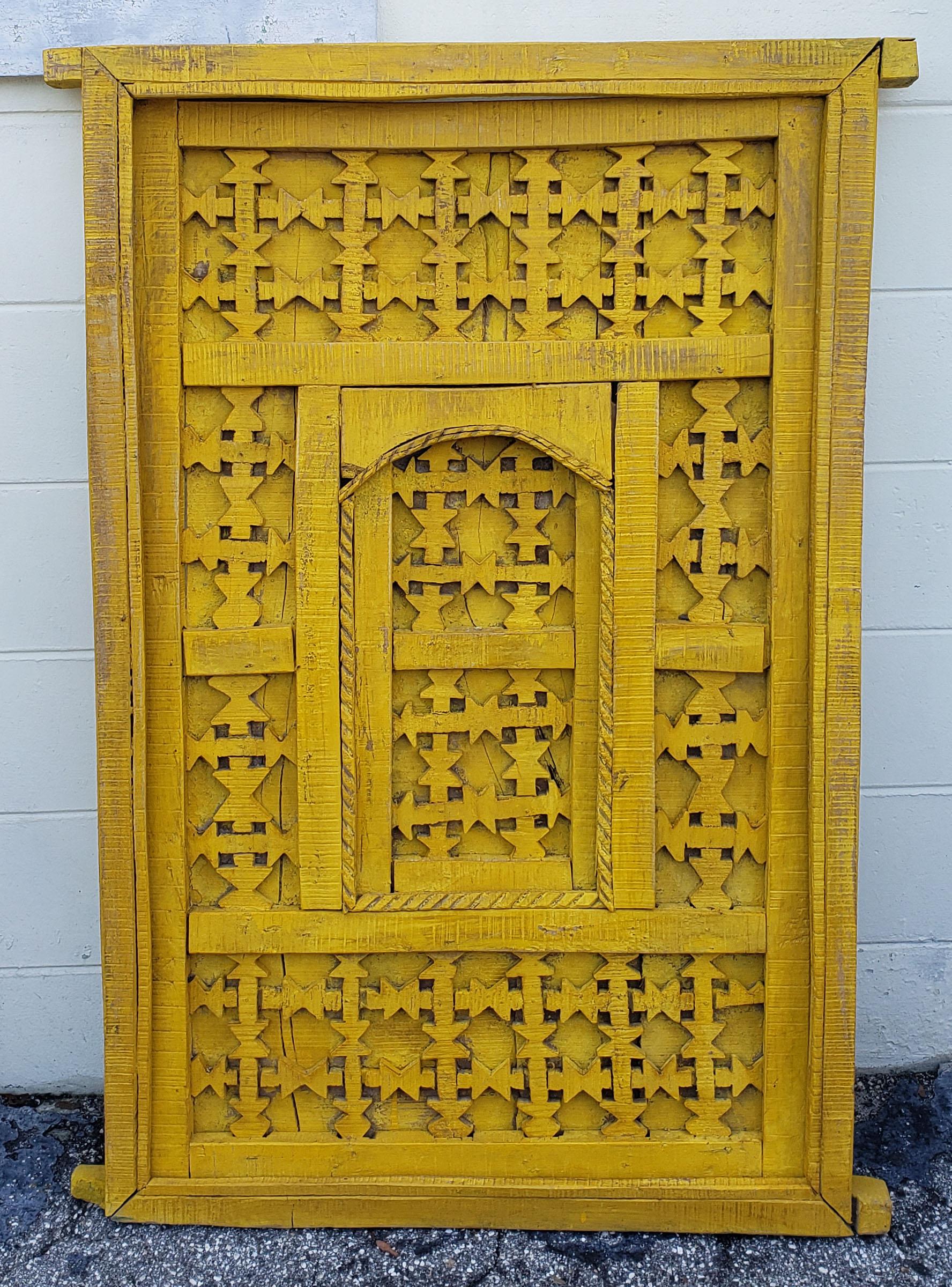 Very old and traditional Moroccan door, gate, or shutter. This door was taken from an old home in the Marrakech Medina when the house was being destroyed. Distressed in a yellow color. Dimensions are approximately 50