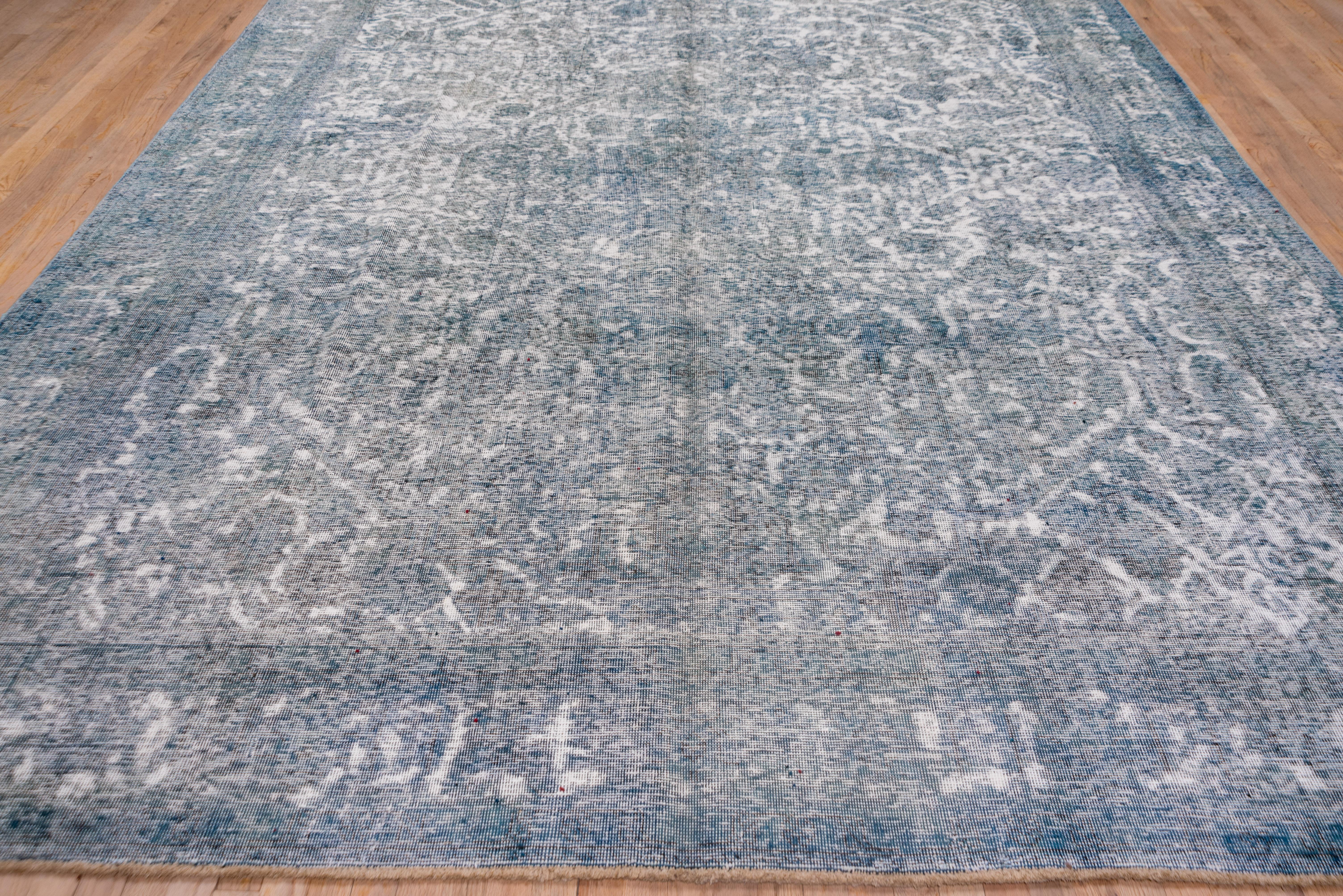 A blue and green overdyed rug on a busy leaf and palmette pattern. Palmette border. Moderate weave, cotton foundation, all over wear nearing distress. Overdye consolidates the palette into fewer distinct tones Fair condition. Sheared all over to