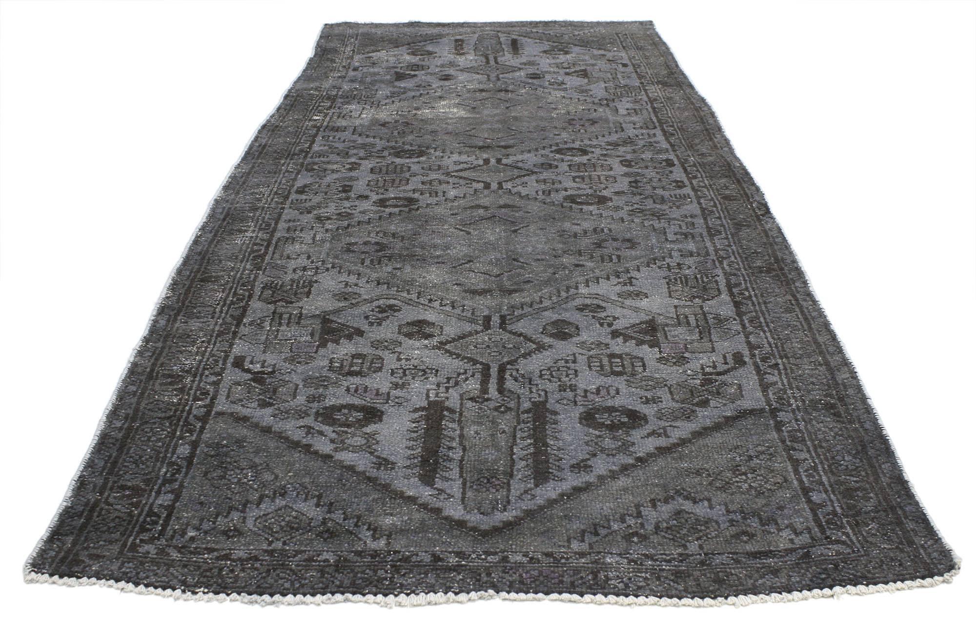 80422, distressed overdyed vintage Persian runner modern Industrial style. This distressed overdyed vintage Persian runner features a modern Industrial style. Characterized by two serrated style medallions with a geometric design and overdyed in