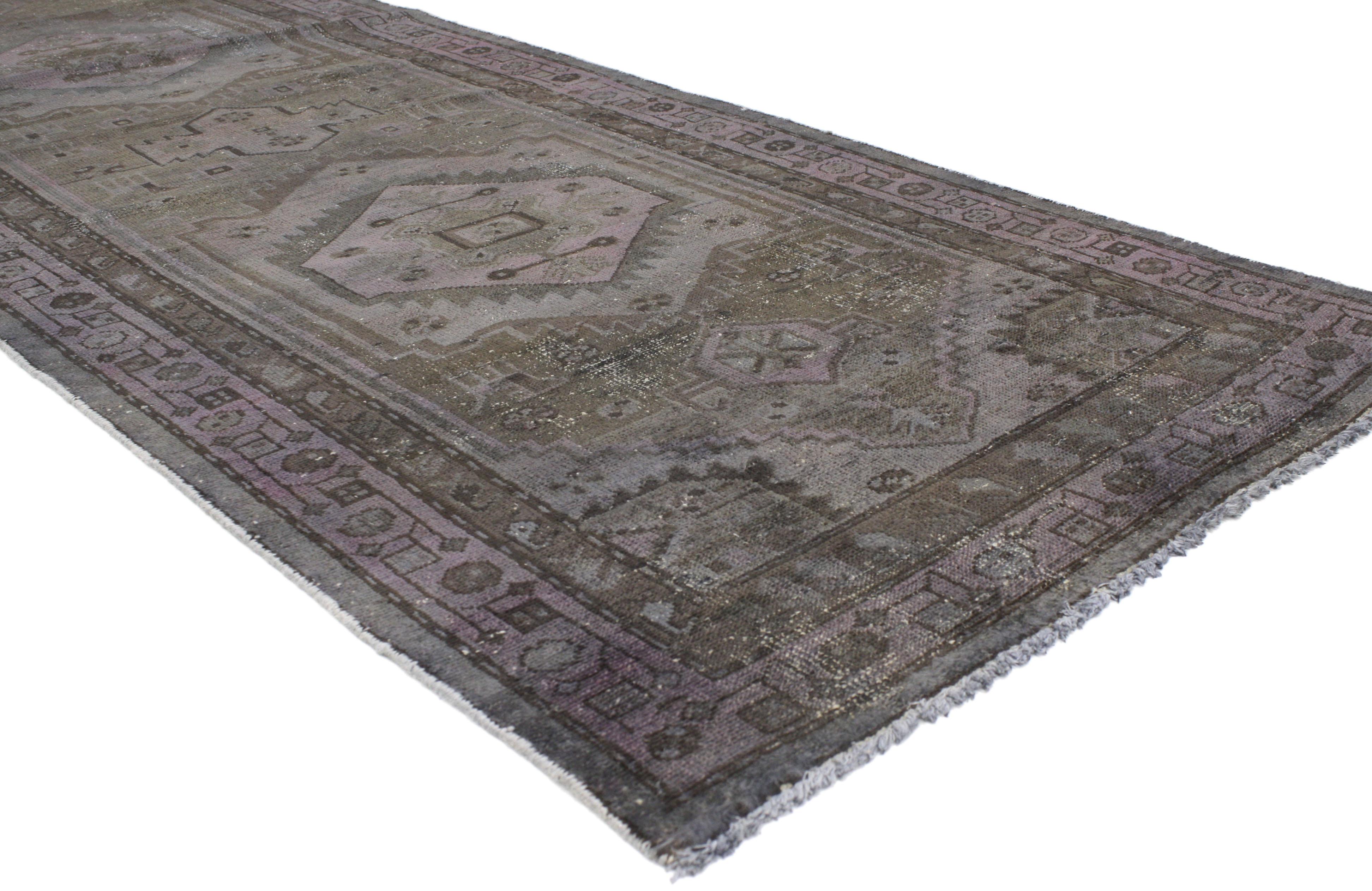 80420, distressed overdyed vintage Persian runner modern Industrial style. This distressed overdyed vintage Persian runner features a modern Industrial style. Characterized by two medallions with a geometric design and overdyed in variegated shades