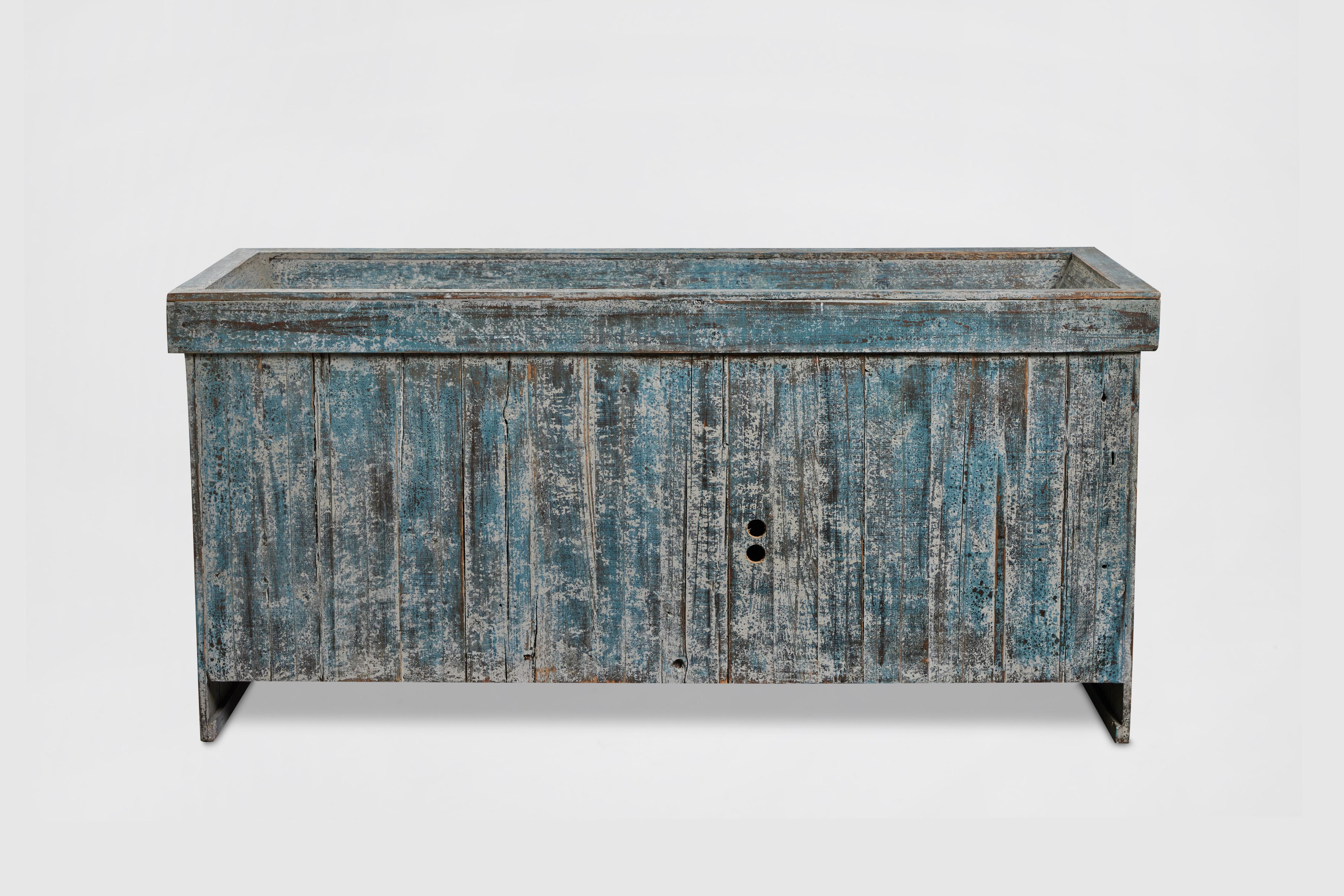 Late 20th Century white oak plank-front sideboard with distressed paint, blue-green and white. Two cabinet doors with tab latches, holes in back for cables. Would make a great media console as well. 

Made by John Hall Design, Los Angeles, 1995. 