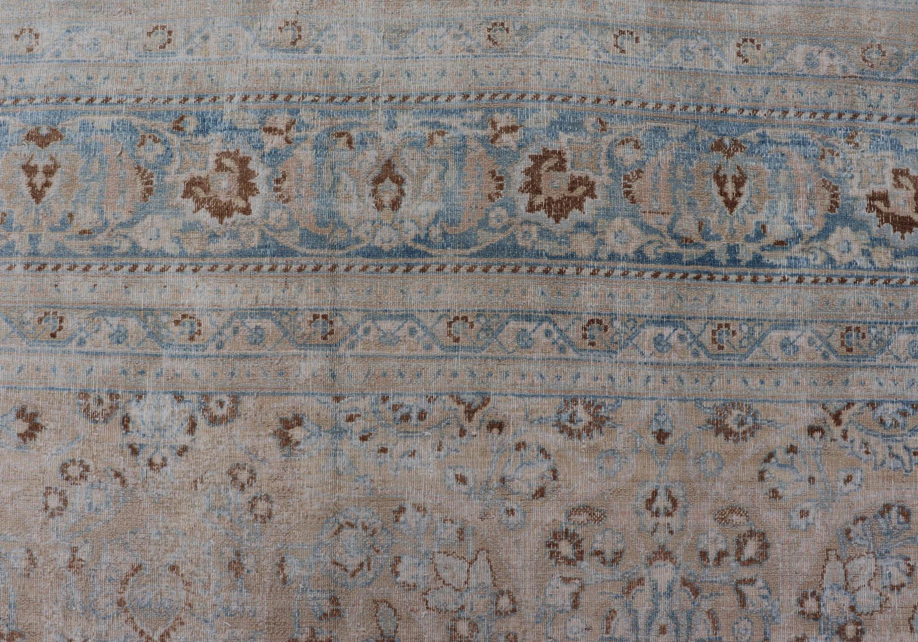 Tabriz Distressed Persian Antique Mashhad Carpet with Muted Floral and Medallion Design For Sale
