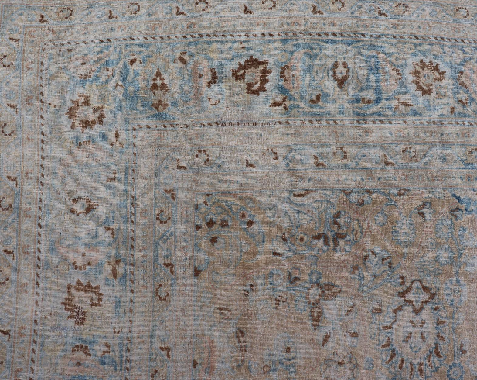 20th Century Distressed Persian Antique Mashhad Carpet with Muted Floral and Medallion Design For Sale