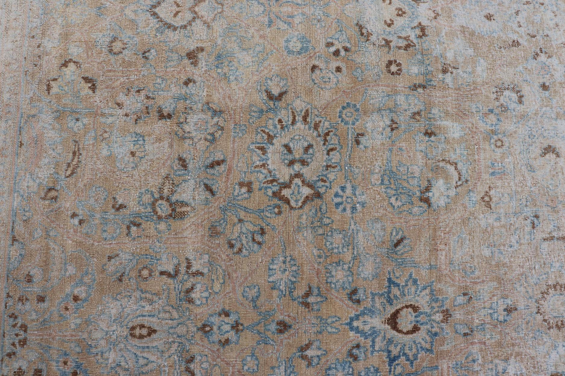 Wool Distressed Persian Antique Mashhad Carpet with Muted Floral and Medallion Design For Sale