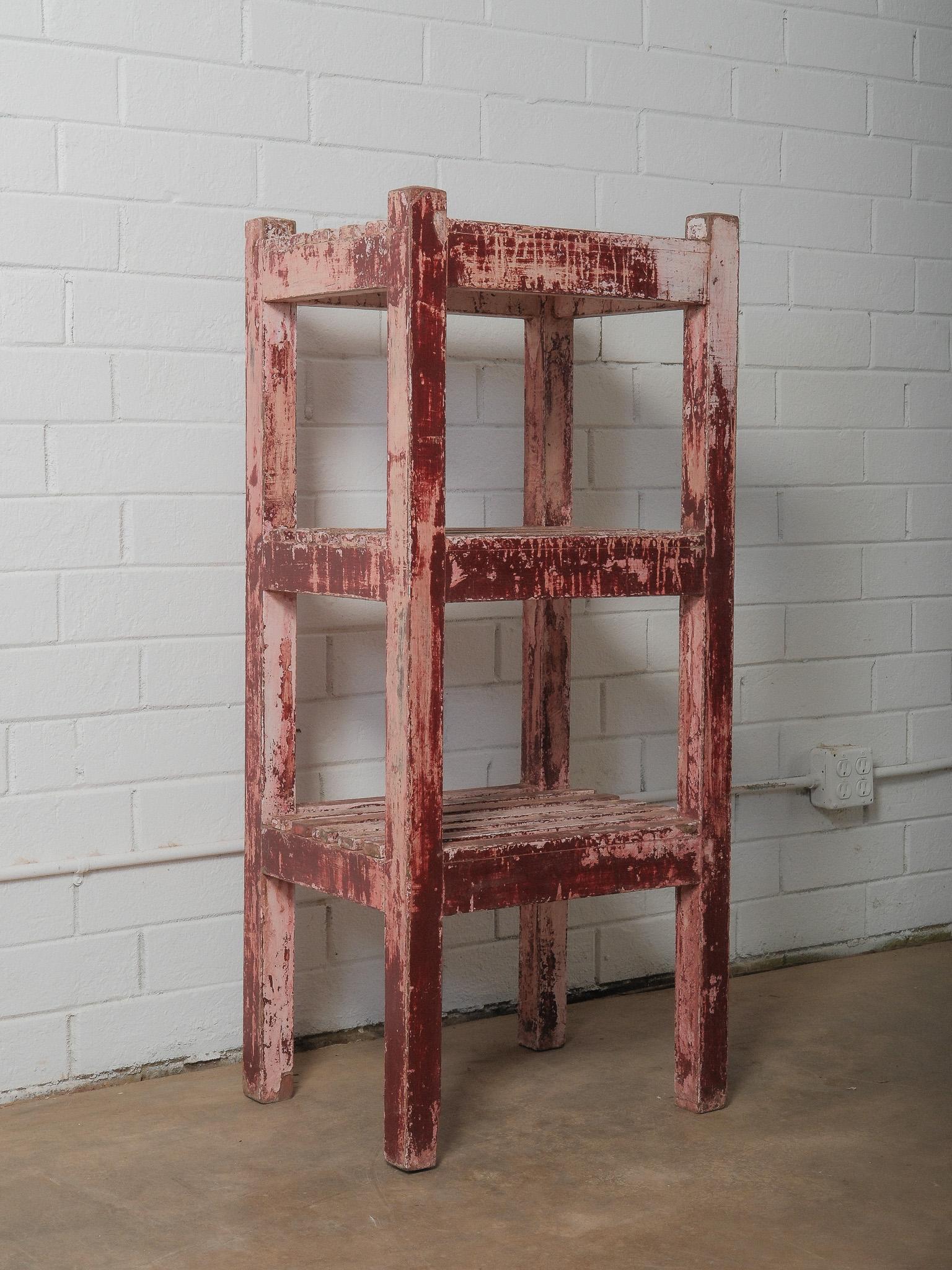 Rustic Distressed Red Wooden Shelf with Layered Patina For Sale