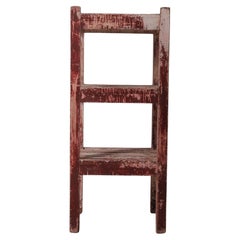 Distressed Red Wooden Shelf with Layered Patina