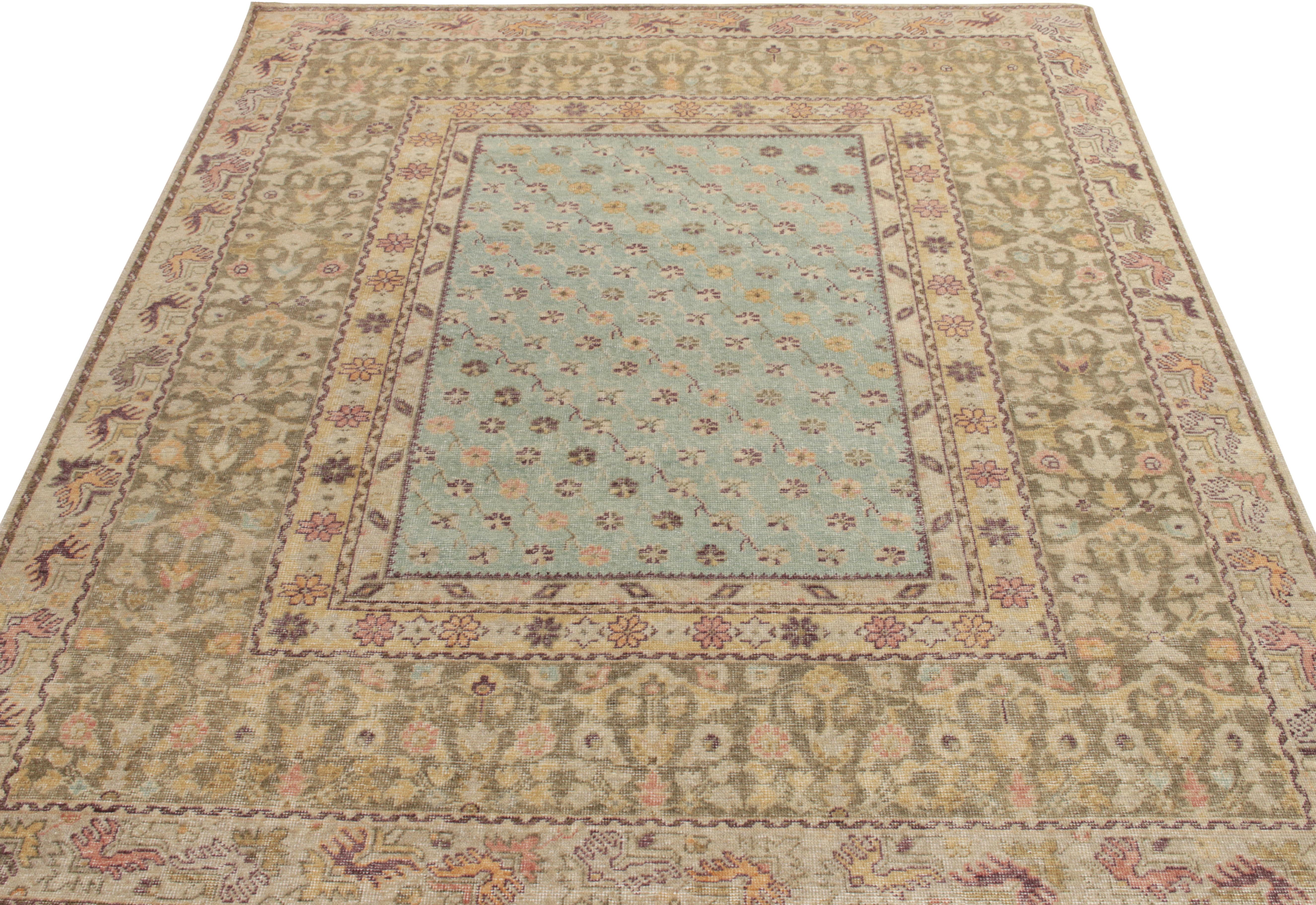 An 8 x 10 distressed style rug from Rug & Kilim’s Homage collection inspired by mid-century European style in muted tones of aubergine, olive green,cream & sky blue transitioning joyfully into a floral pattern relishing classic aesthetics for