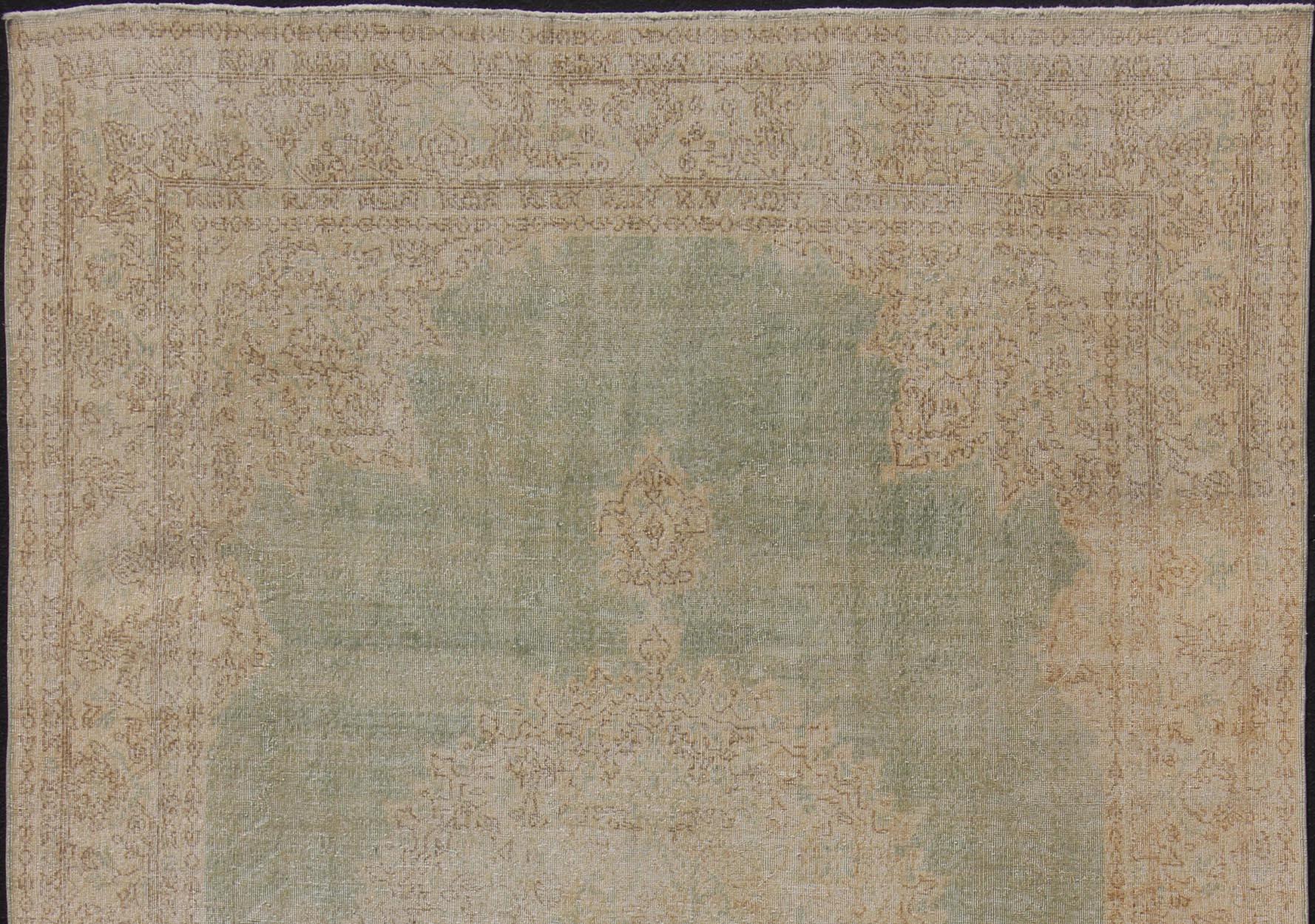 Hand-Knotted Distressed Turkish Carpet with Floral Medallion in Light Green, Tan and Taupe For Sale