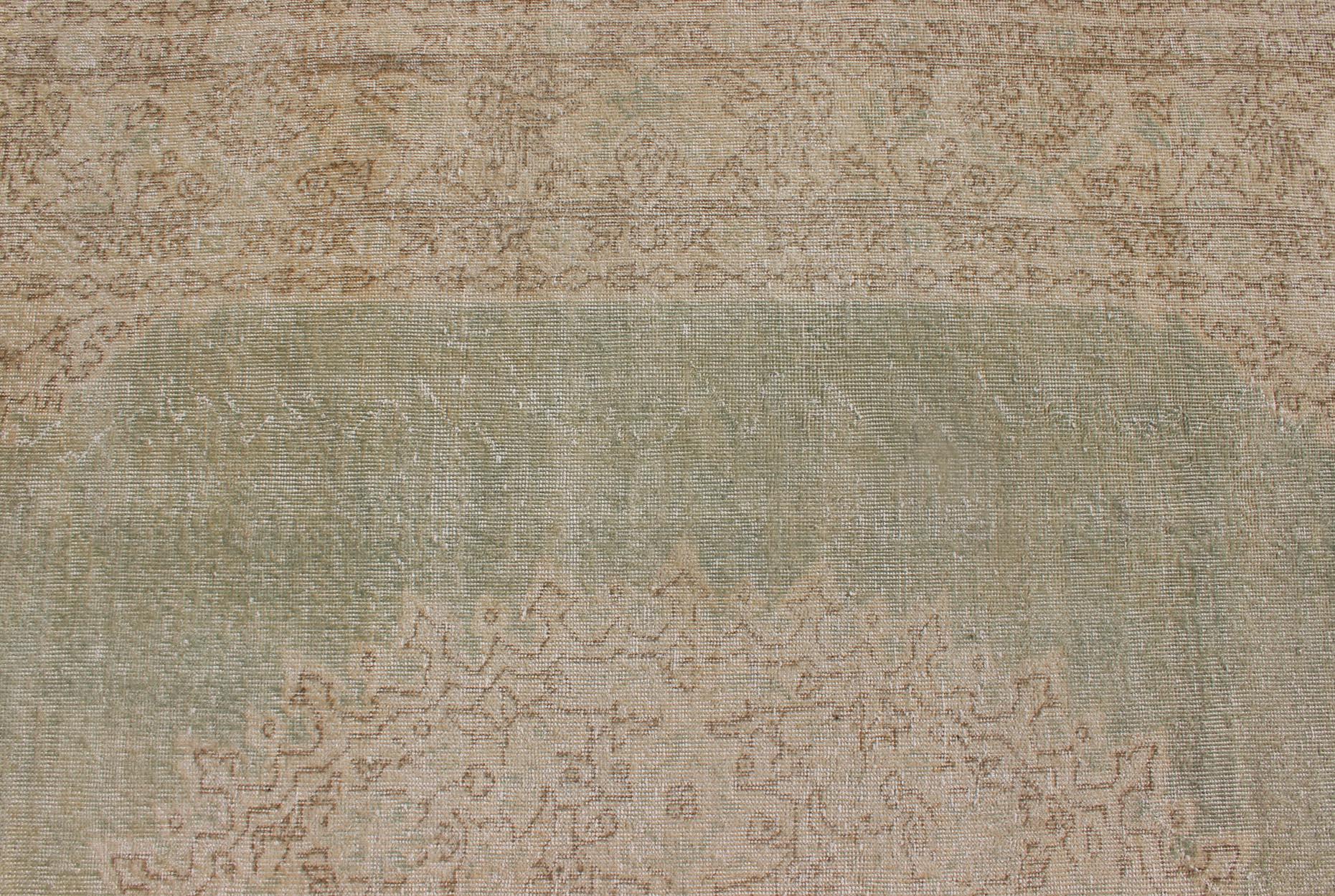 Mid-20th Century Distressed Turkish Carpet with Floral Medallion in Light Green, Tan and Taupe For Sale