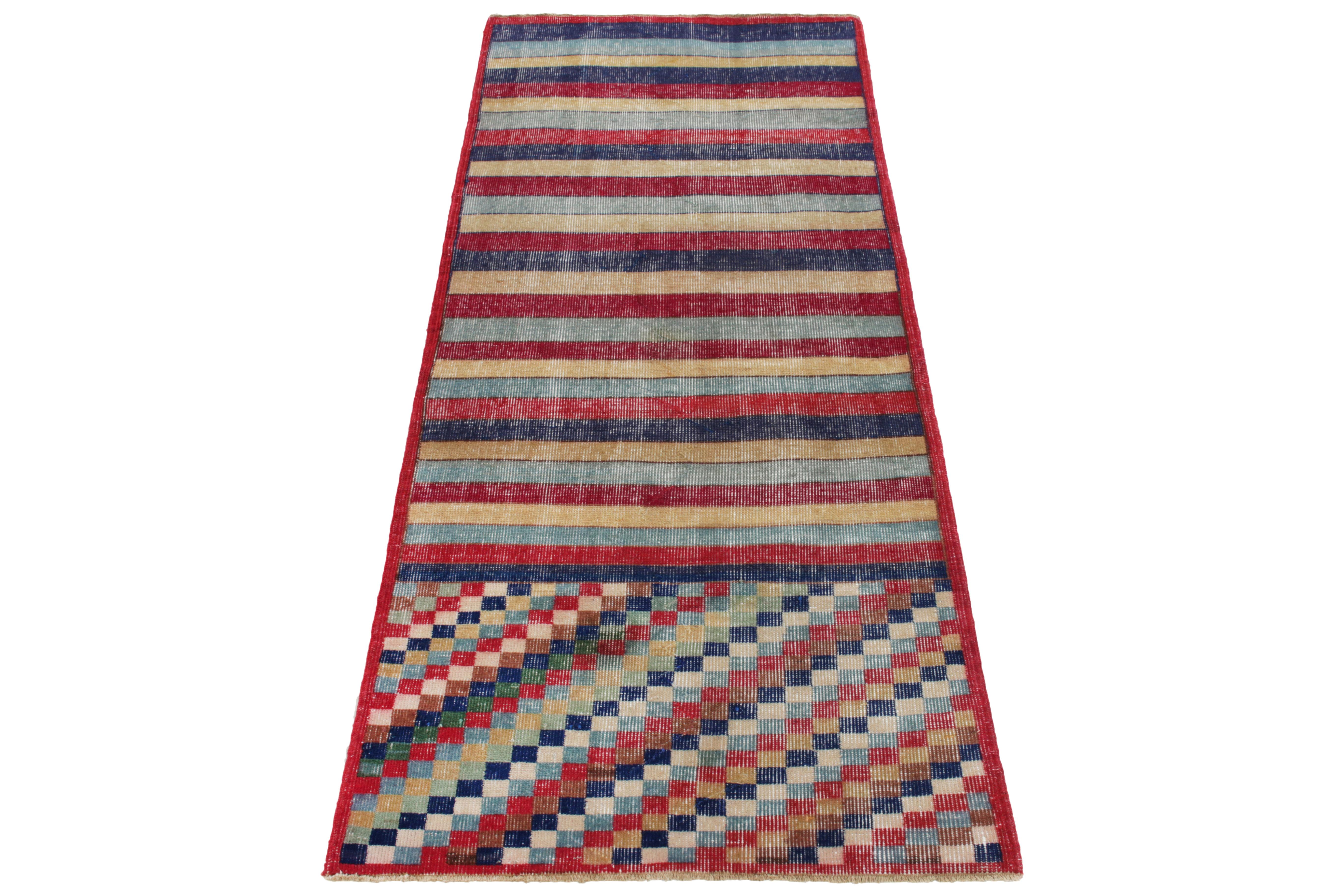 Hand-knotted in wool circa 1960-1970, a 3x7 vintage runner from a bold Turkish designer commemorated in Rug & Kilim’s Mid-Century Pasha Collection. The piece witnesses exceptional pagination with geometric & striped patterns in red, blue, beige &