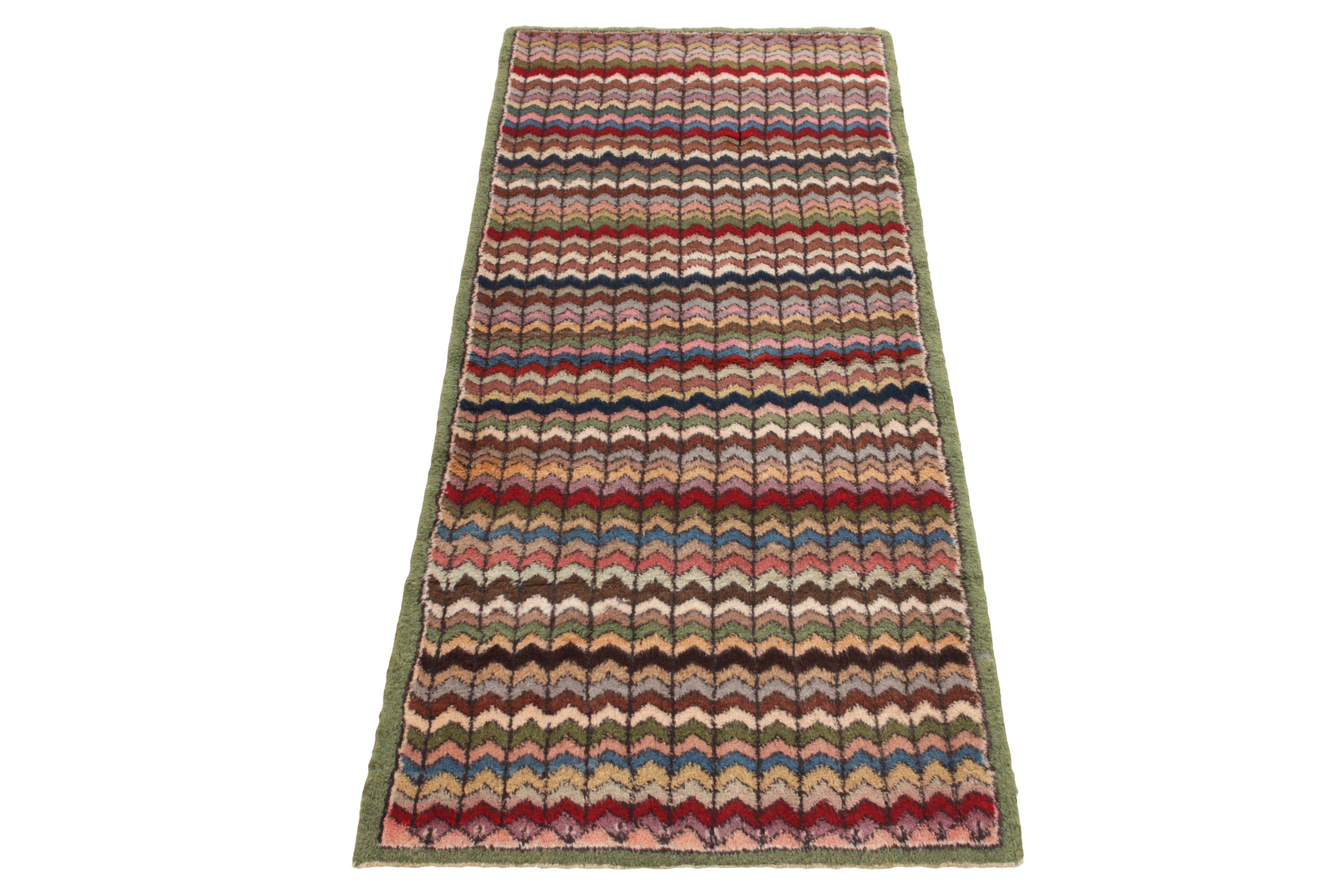 Hand-knotted in wool, a 3x7 vintage runner from a bold Turkish designer commemorated in Rug & Kilim’s Mid-Century Pasha Collection. The 1960s piece witnesses exceptional pagination with repetitive chevron patterns in red, blue, yellow, pink, beige &