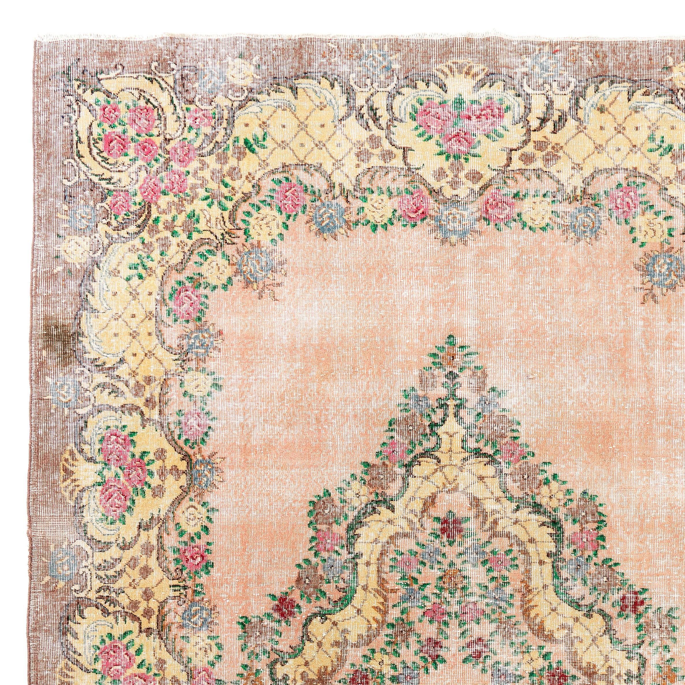 A finely hand-knotted vintage Turkish carpet from the 1960s featuring an ever popular European garden design in glowing tones of peach and yellow with touches of pink, red and cinnamon. Measures: 7.4 x 11 Ft

The rug has even low wool pile on cotton