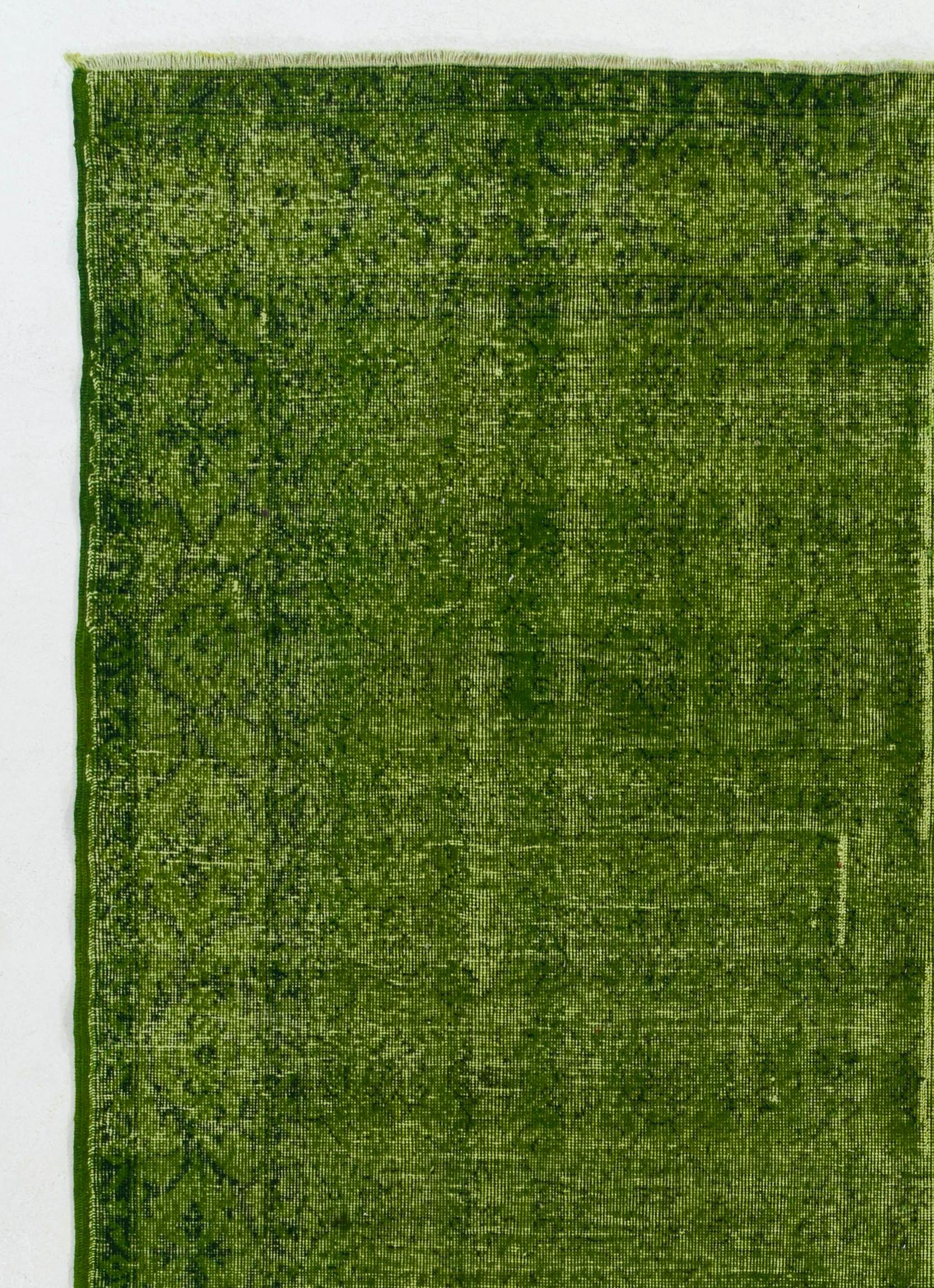 A vintage Turkish area rug re-dyed in green color for contemporary interiors. 
Finely hand knotted, low wool pile on cotton foundation. Professionally washed.
Sturdy and can be used on a high traffic area, suitable for both residential and