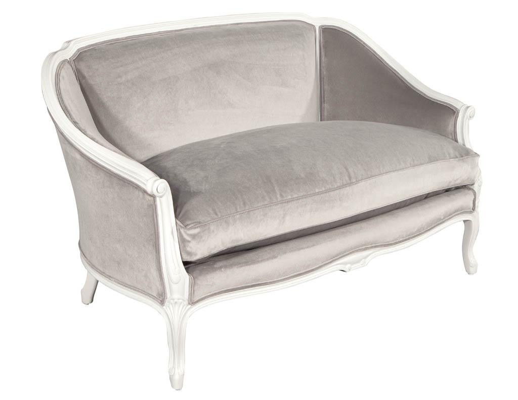 Distressed vintage Louis XV style settee sofa. Original 1940's made in the USA, fully restored in a distressed Chantilly Lace lacquer finish. Newly upholstered in a designer grey velvet.

Price includes complimentary curb side delivery to the