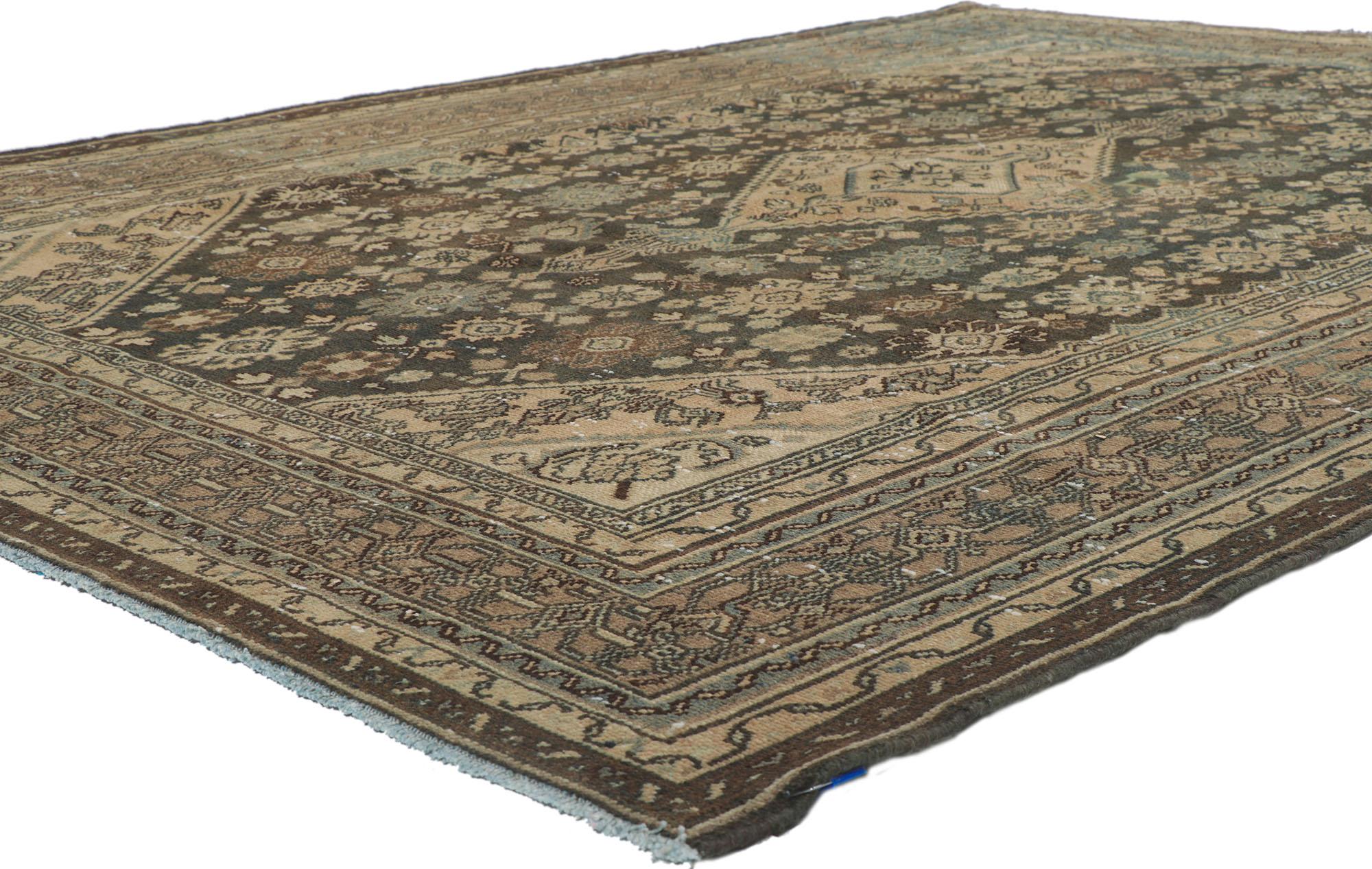 61007 Distressed Vintage Persian Hamadan Rug, 06'10 x 09'07.
Luxury lodge meets relaxed refinement in this hand knotted wool distressed vintage Persian Hamadan rug. The intrinsic tribal design and earthy colorway in this piece seamlessly blend to