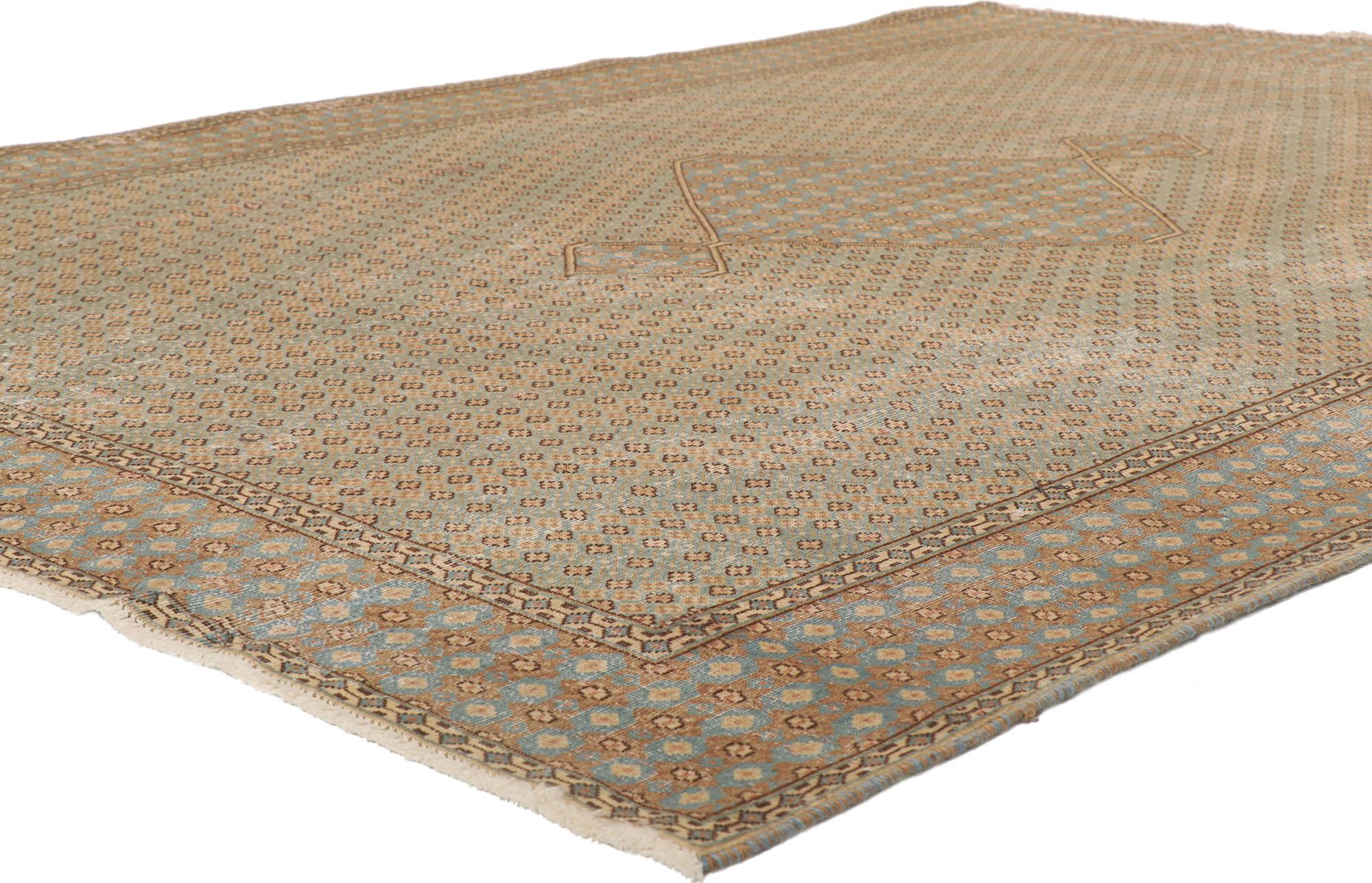 53759 Distressed Vintage Persian Kerman Rug, 06'10 x 09'06.
Laid-back luxury meets quiet sophistication in this hand knotted wool distressed vintage Persian Kerman rug. Let yourself be whisked away on a journey of tranquility, as you step onto this
