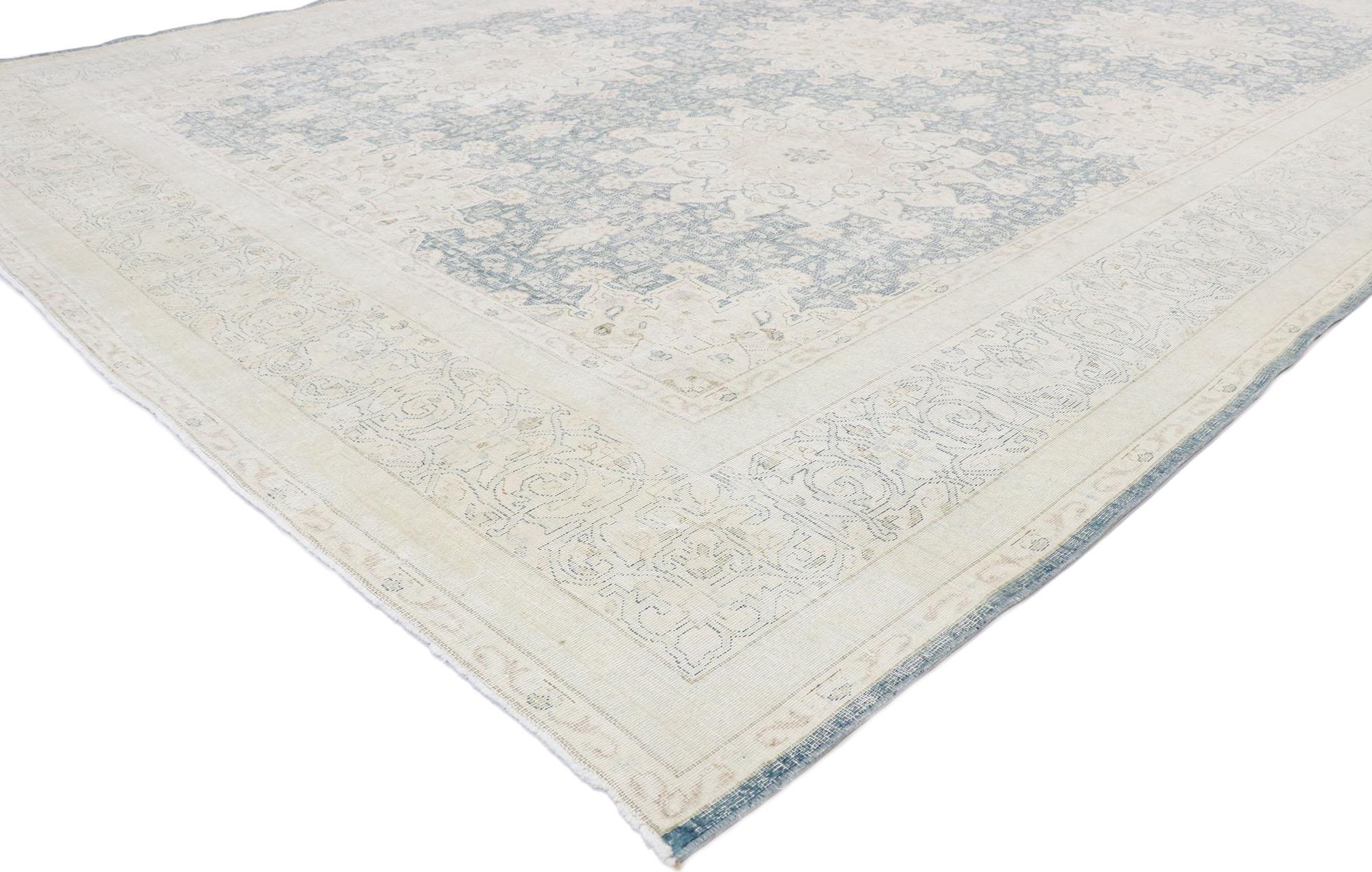53393, distressed vintage Persian Kerman Rug with English Country Cottage style. Light and airy with rustic sensibility, this hand knotted wool vintage Persian Kerman rug is poised to impress. The antique washed field features five round starburst