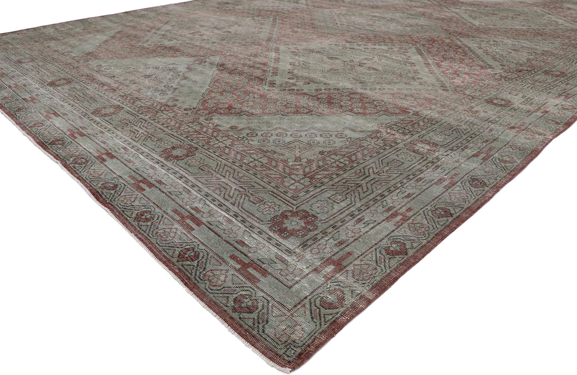 53248 Distressed Antique Persian Khotan rug with American Colonial Williamsburg style. With timeless appeal and fine craftsmanship with rustic sensibility, this hand knotted wool distressed antique Persian Khotan rug beautifully embodies American