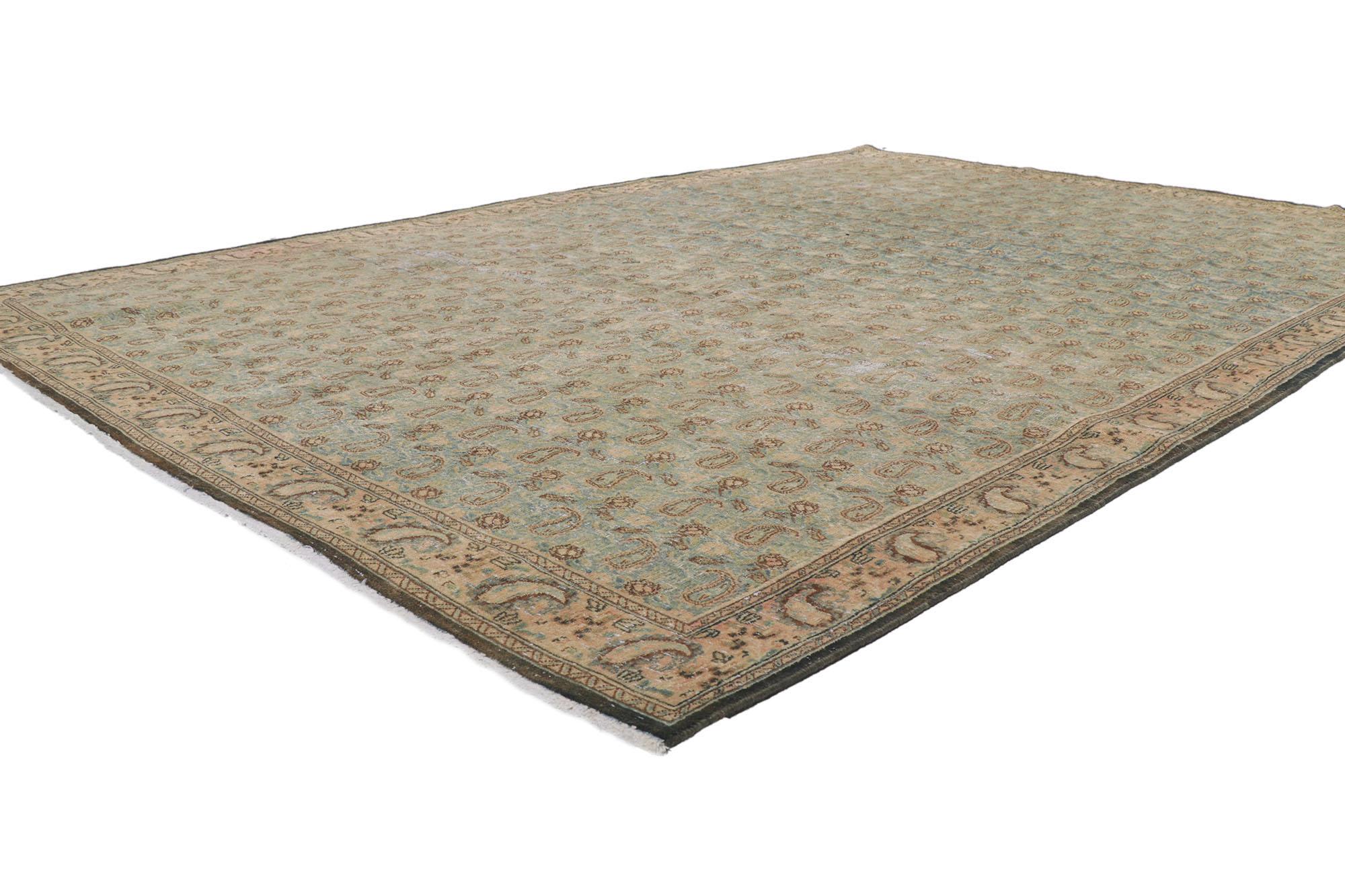 61004 Distressed Vintage Persian Qum Rug, 06'09 x 09'05.
Weathered finesse meets ivy league prep in this hand knotted wool distressed vintage Persian Qum rug. The allover paisley design and antique-washed colors in this piece work together creating