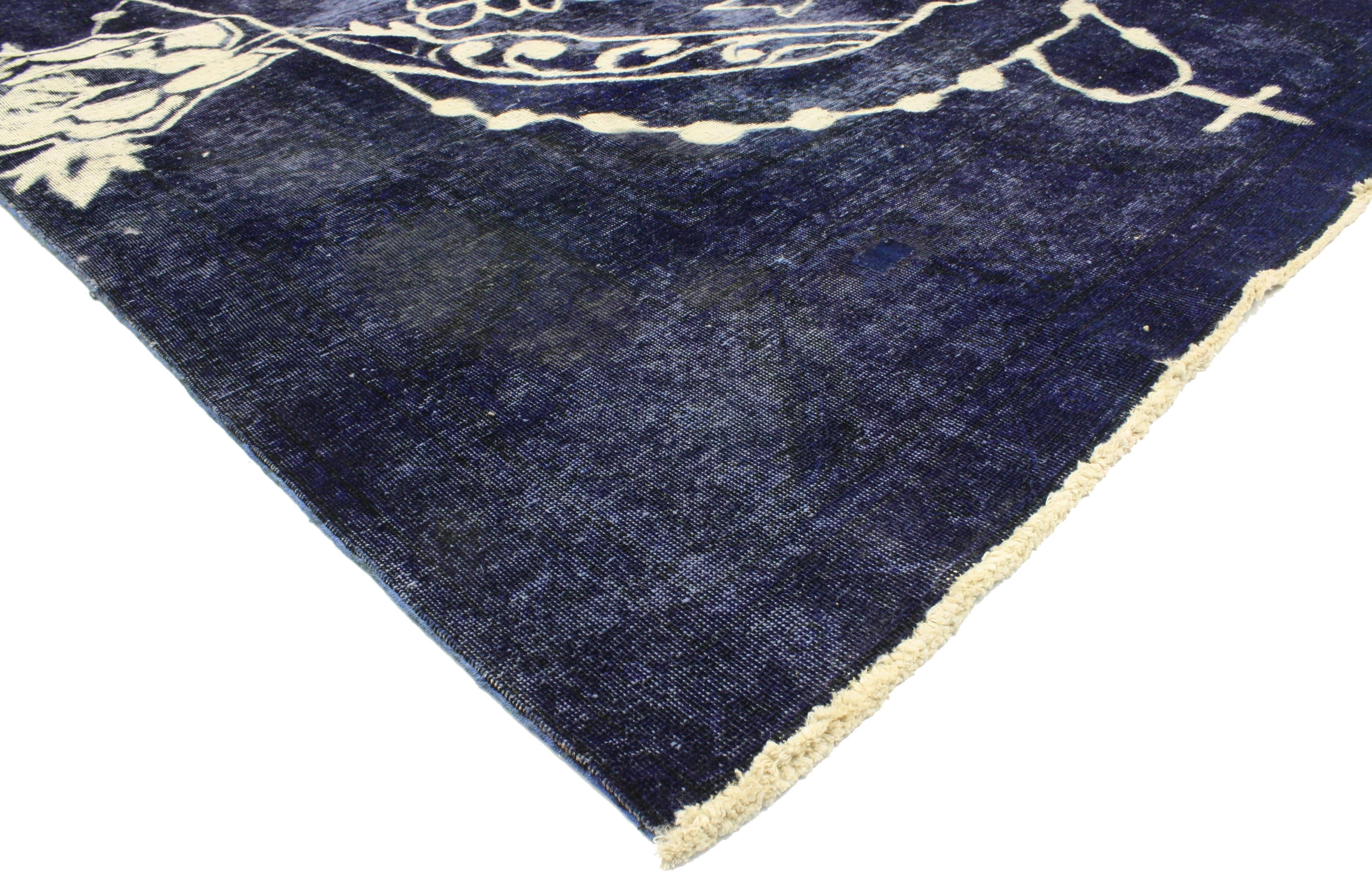 80273, Vintage Overdyed Blue Skull Rug Inspired by Alexander McQueen
07'08 x 11'02. Drawing inspiration from Alexander McQueen, Día de los Muertos, and Disney's Coco movie, this hand knotted wool distressed vintage Calavera skull area rug has been
