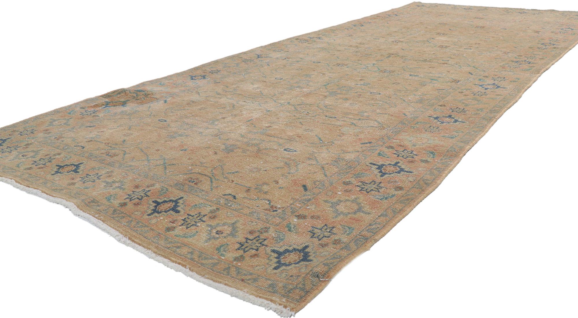 61012 Distressed Vintage Persian Tabriz Rug, 04'02 x 10'11.
Get ready for an enthralling adventure as you get swept away by the warm and comforting embrace of this meticulously hand-knotted wool distressed vintage Persian Tabriz rug. Immerse