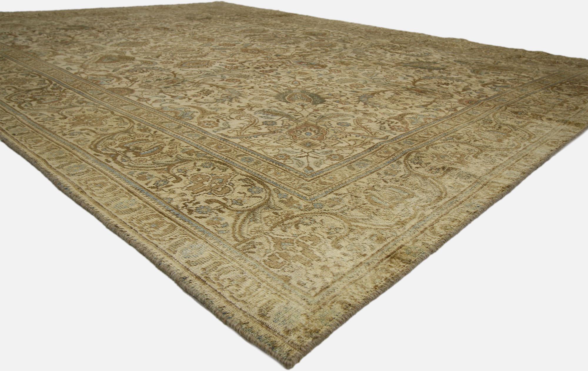 60728, distressed vintage Tabriz rug with warm, neutral colors. A beautiful bounty of Herati, acanthus leaves, florals, blooming palmettes, and peonies fill the center field of this distressed vintage Tabriz Persian rug. Decadence and nature's