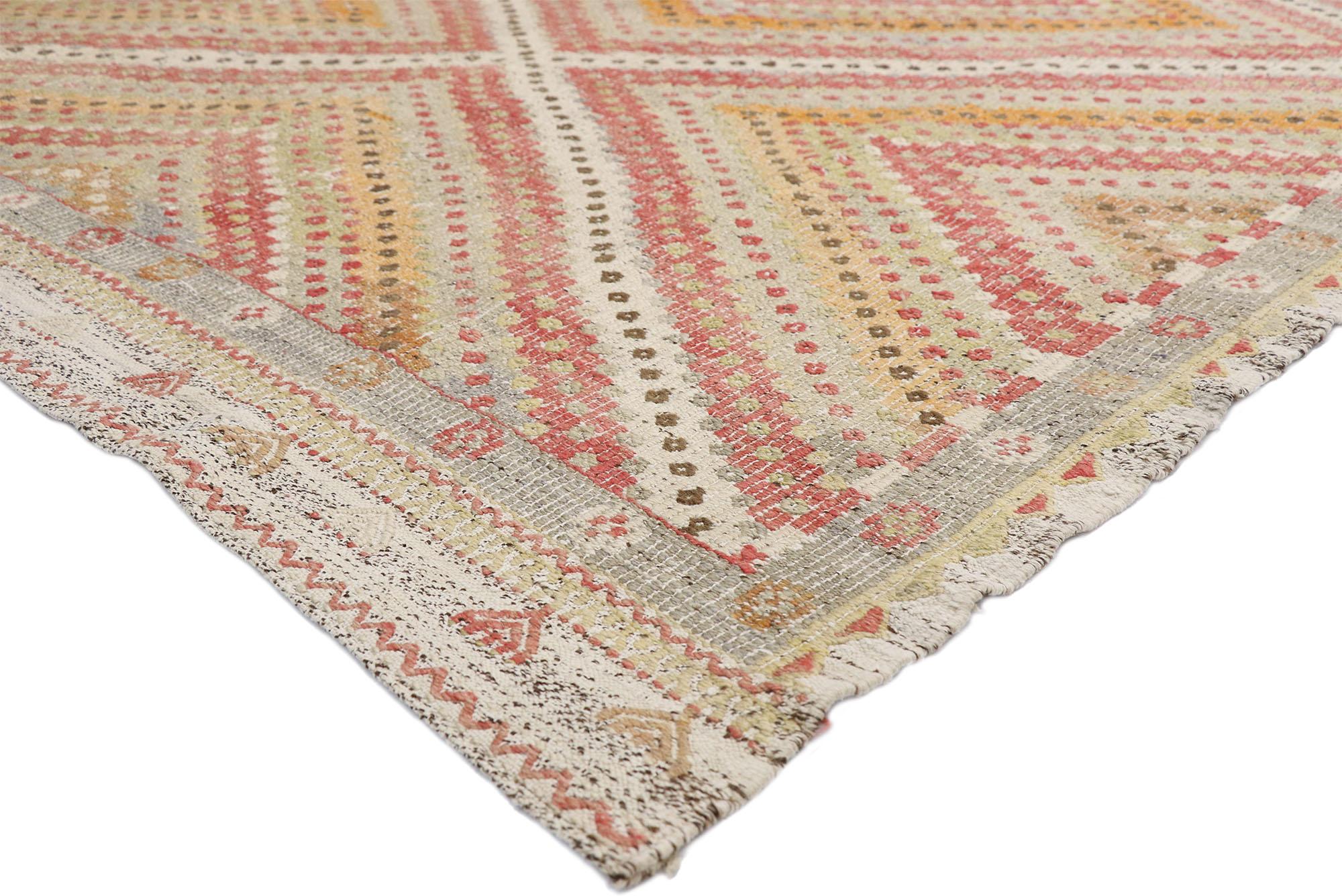 52561, distressed vintage Turkish Kilim rug with Southern Living British Colonial style. This handwoven wool vintage Turkish Kilim rug features a central diamond surrounded by additional striped bands creating an Expansion effect for the main