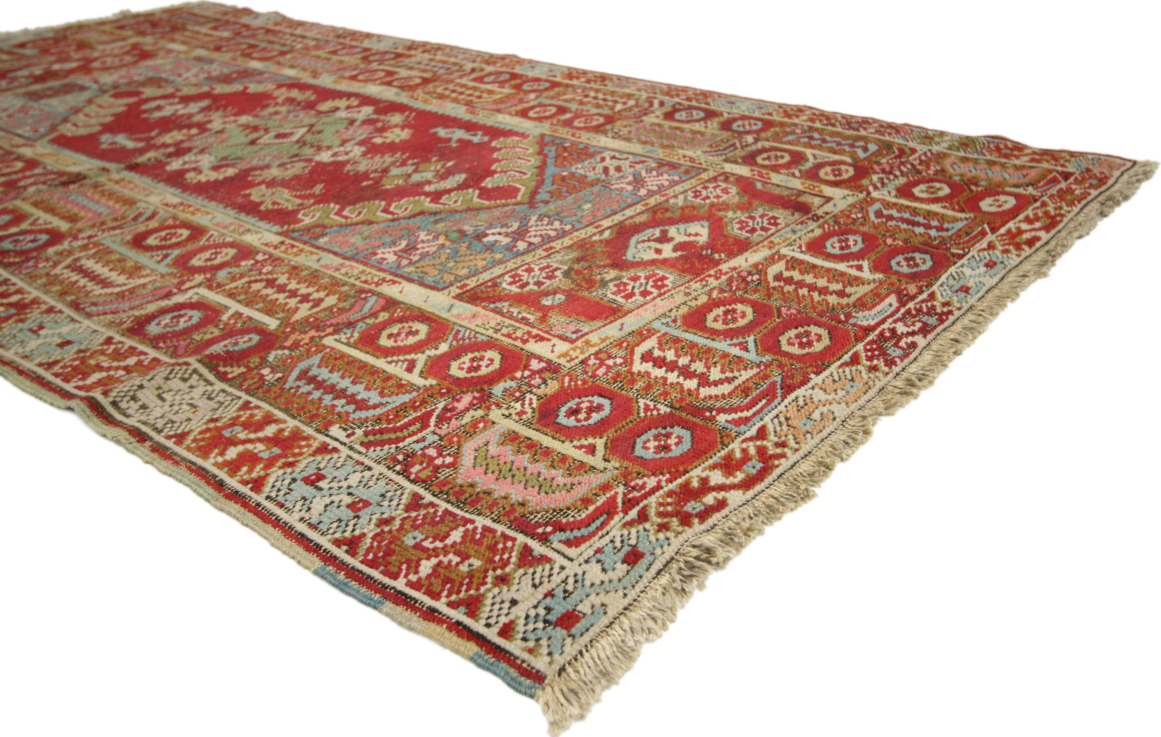 51339 Distressed Vintage Turkish Oushak Accent Rug with Industrial Tribal Style. This hand knotted wool distressed vintage Turkish Oushak accent rug features a centre medallion with extending blooming botehs dotted with jugs, lozenges, and organic