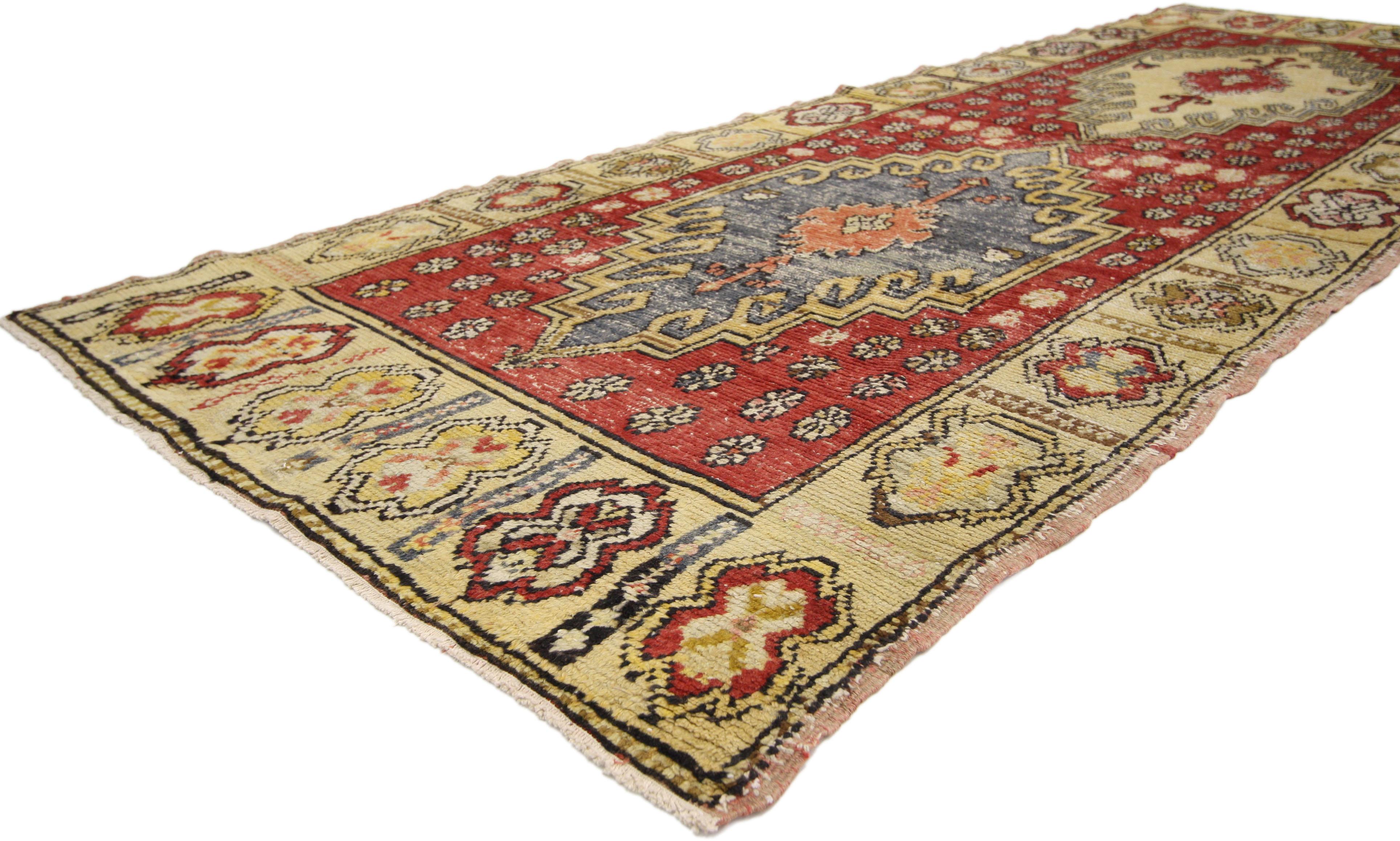50317, distressed vintage Turkish Oushak hallway runner with Arts & Crafts style. This hand knotted wool distressed vintage Turkish Oushak runner features two stepped hexagonal medallions floating on an abrashed red field. The medallions each