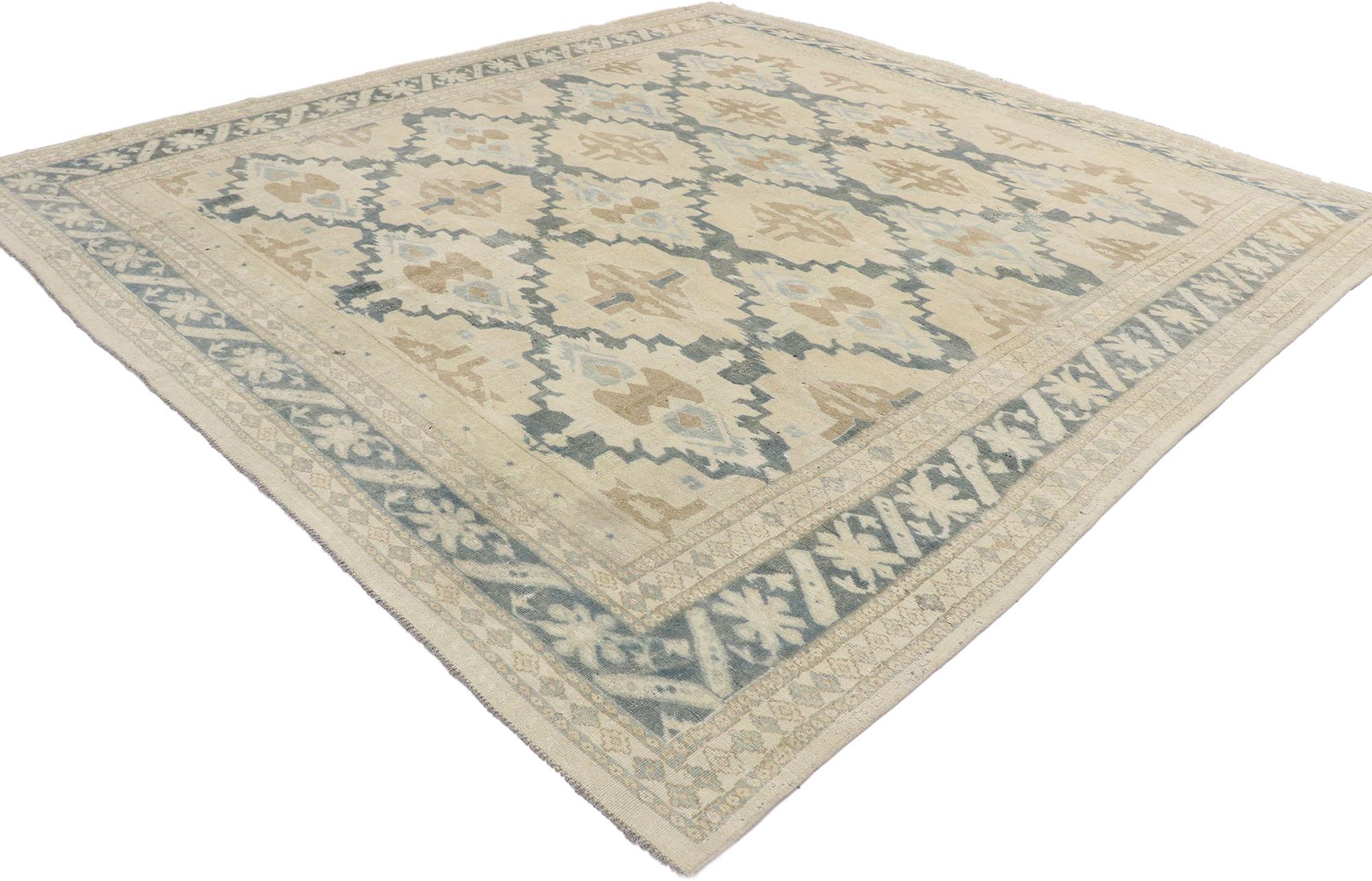53243 distressed vintage Turkish Oushak rug with Coastal Arts & Crafts style. This hand knotted wool distressed vintage Turkish Oushak rug features an all-over pattern of offset rows of large geometricized open blossoms spread across an abrashed