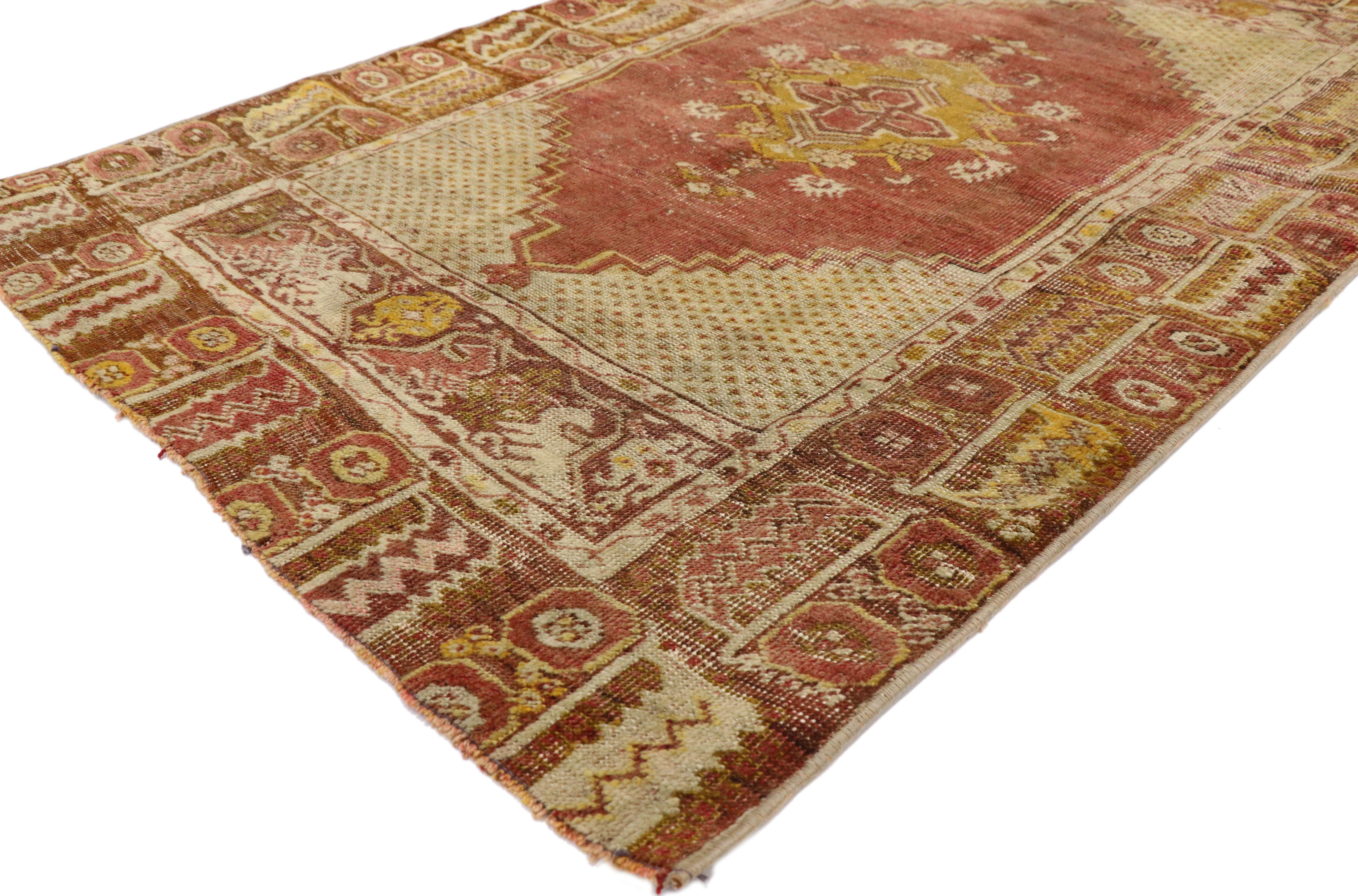 52775 distressed vintage Turkish Oushak rug. With warm spice-tones and lovingly timeworn appearance, this hand knotted wool distressed vintage Turkish Oushak rug embraces modern rustic style. It features a traditional medallion design composed of a