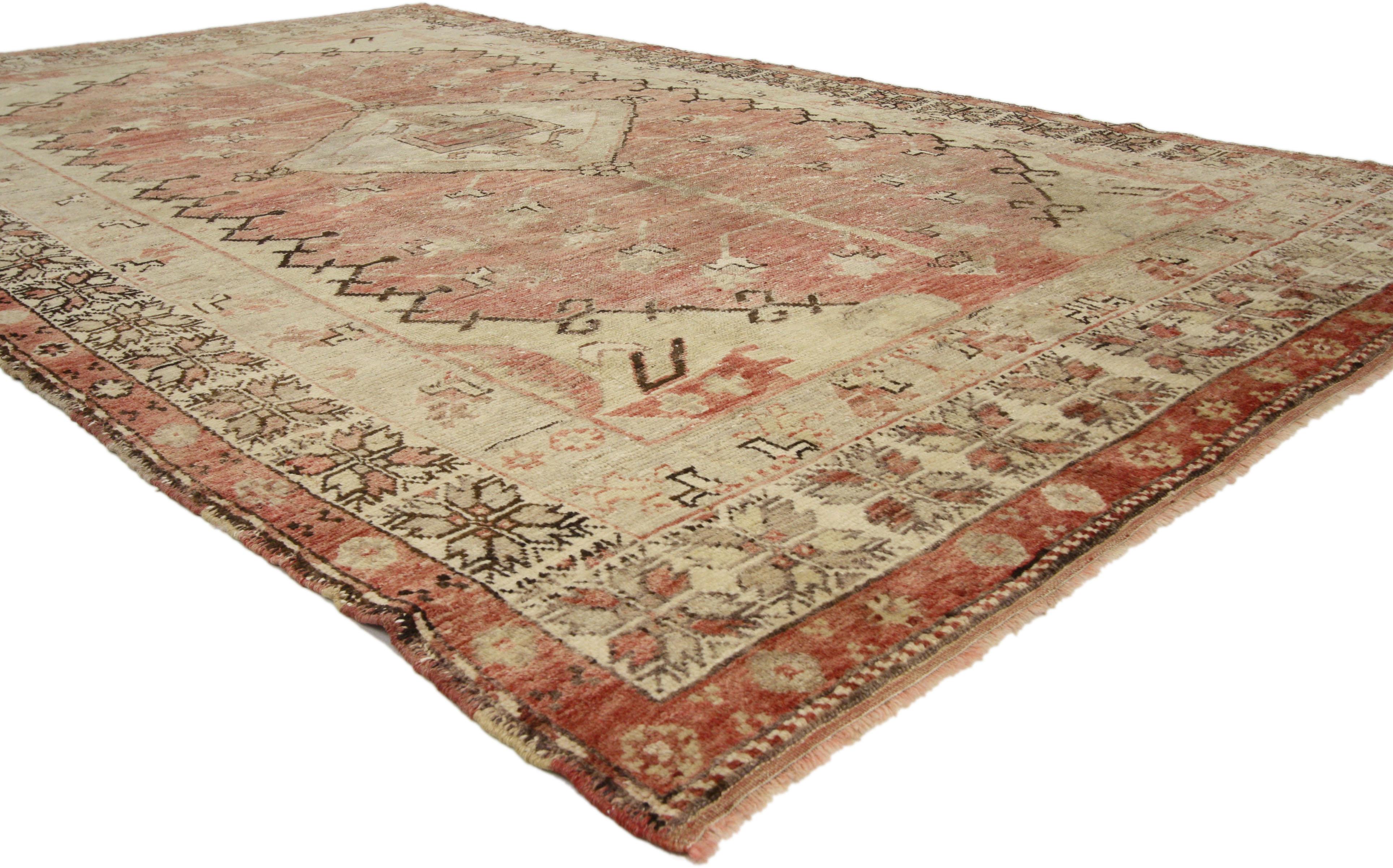 73663, distressed vintage Turkish Oushak rug with rustic Adirondack lodge style. This hand knotted wool distressed vintage Turkish Oushak rug features a pole medallion with tree of life expensions and a central lozenge motif patterned with rosettes