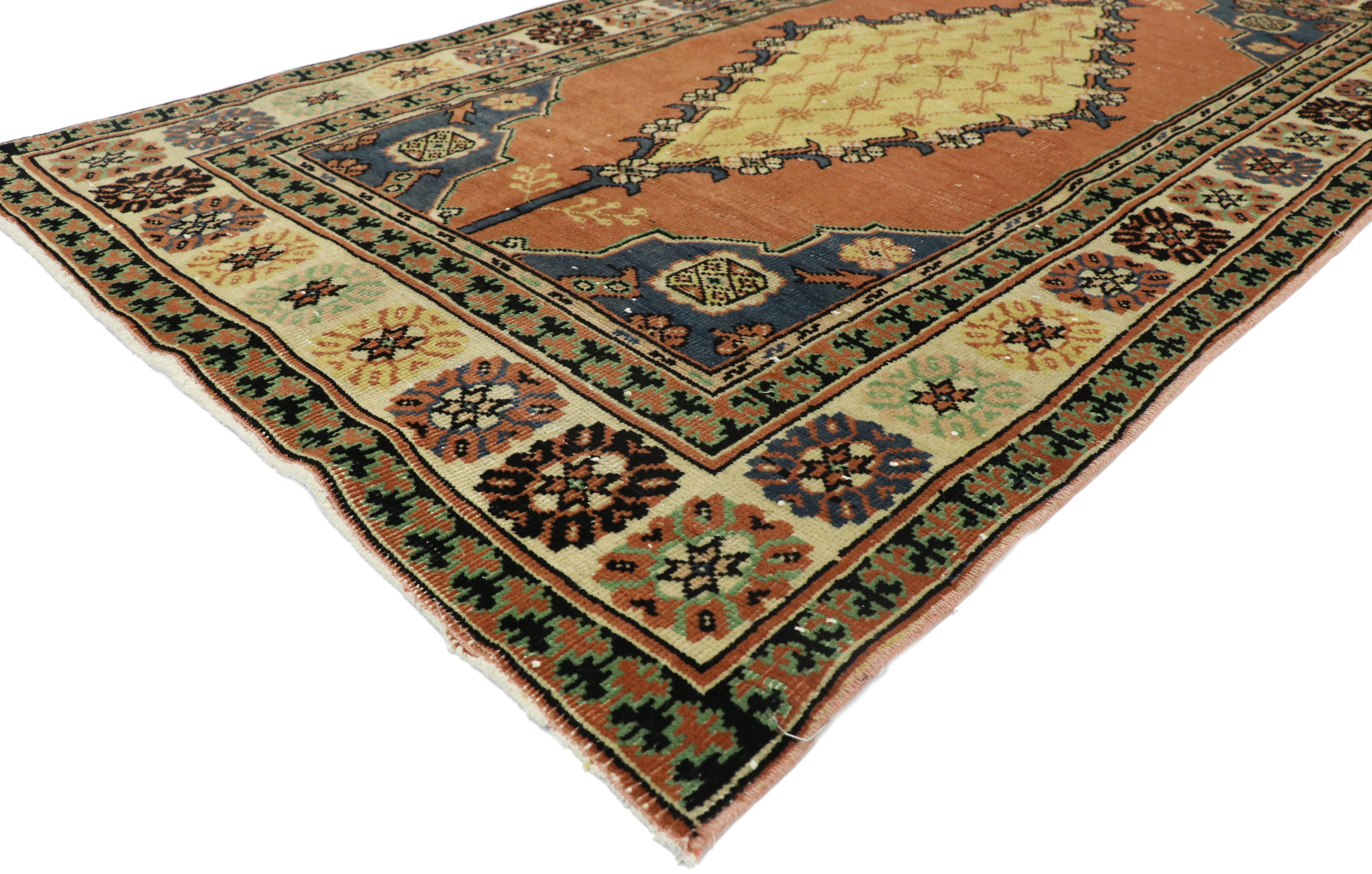 52767, distressed vintage Turkish Oushak rug with rustic Arts & Crafts style. This hand knotted wool distressed vintage Turkish Oushak rug features a central lozenge pole medallion patterned inside with a diamond lattice outlined with alternating