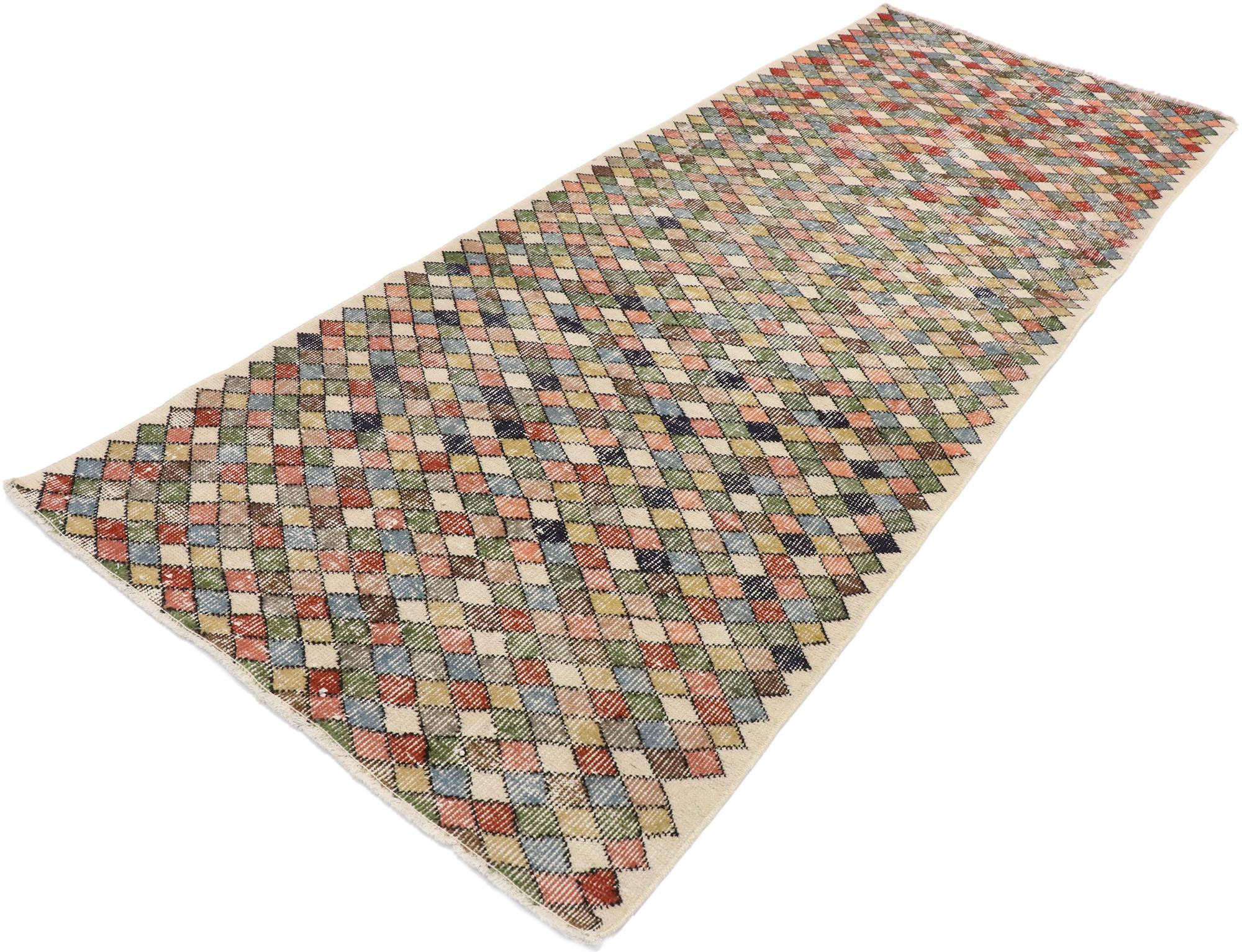 53302, distressed vintage Turkish Sivas rug with Rustic Cubist style. This hand knotted wool distressed vintage Turkish Sivas rug features an all-over checkered pattern comprised of multi-colored diamonds. Gentle waves of abrash and variations in
