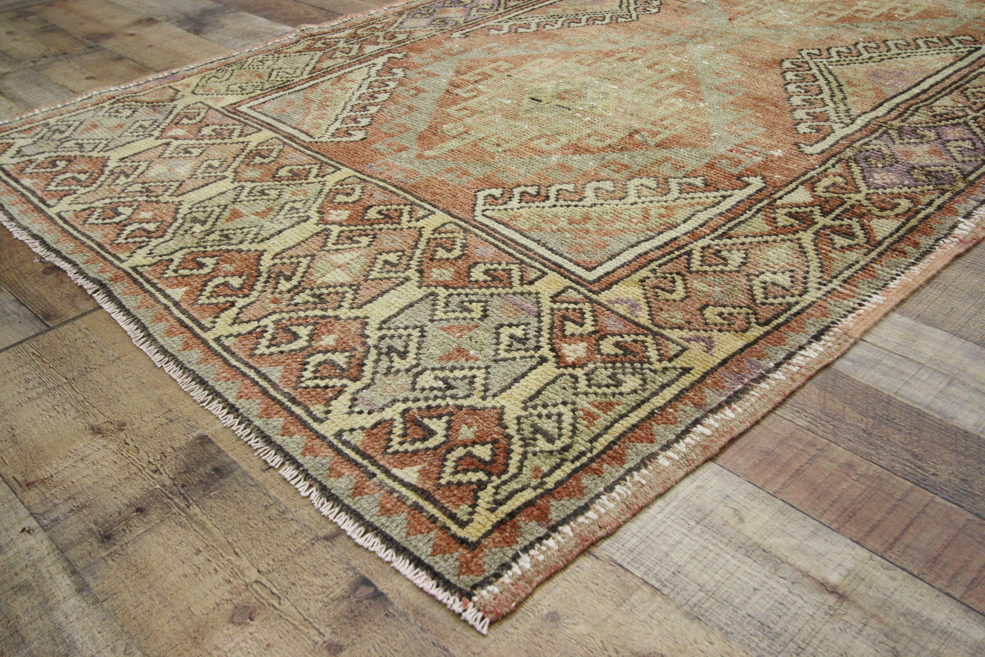 52410 Distressed Vintage Turkish Oushak Runner, Tribal Style Hallway Runner 03'09 x 09'01. This hand-knotted wool vintage Turkish Oushak runner features a triple medallion design of concentric hooked diamonds spread across an abrashed terra cotta