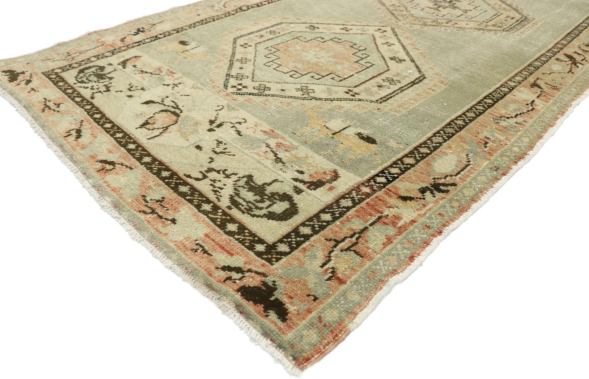 52703, distressed vintage Turkish Oushak runner with Rustic Prairie style. This hand knotted wool distressed vintage Turkish Oushak runner features four hexagonal medallions patterned with symbolic Anatolian motifs in an open abrashed field. A camel